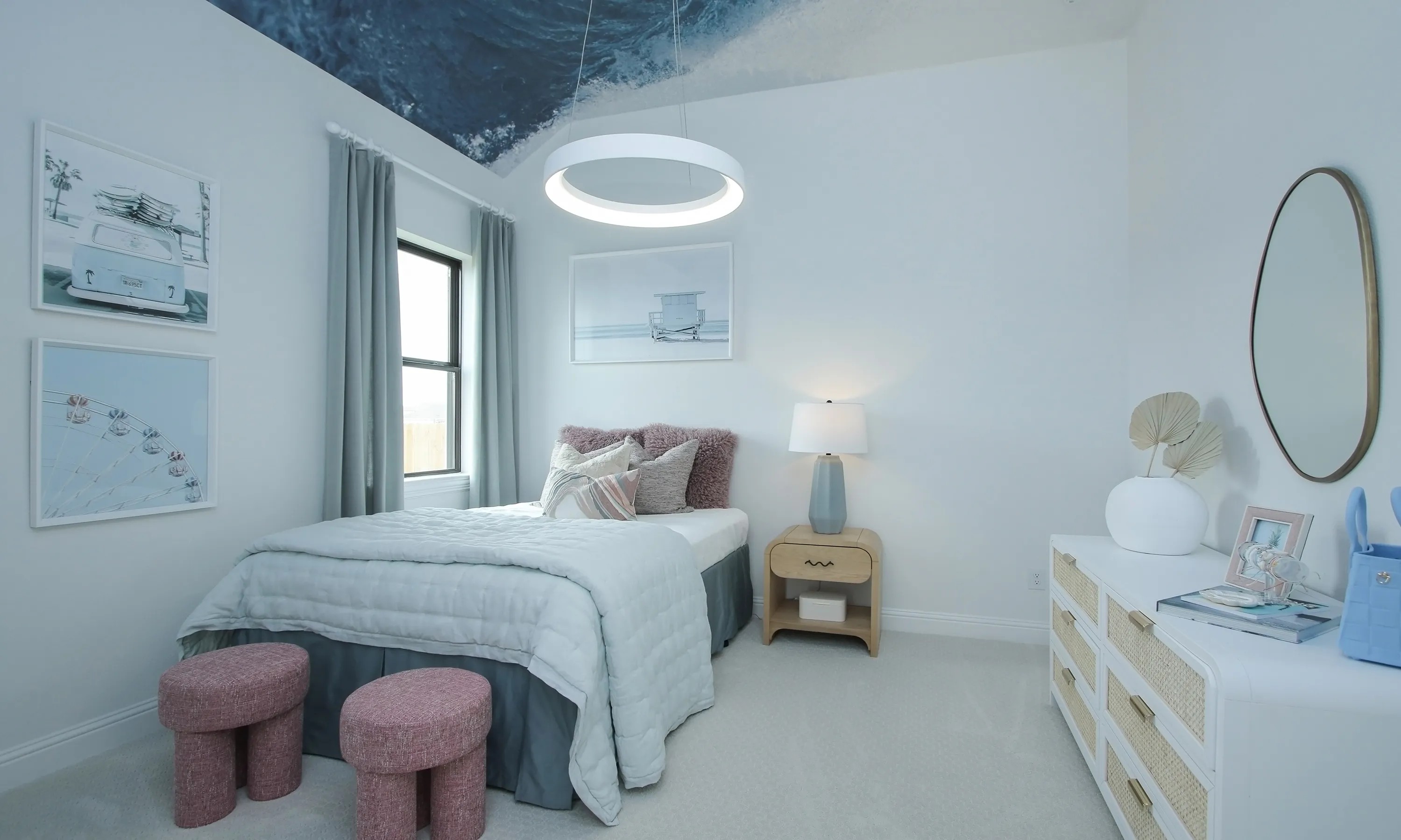 Elegant bedroom with coastal decor, featuring ocean-themed ceiling and plush furniture in Coastal Point community.