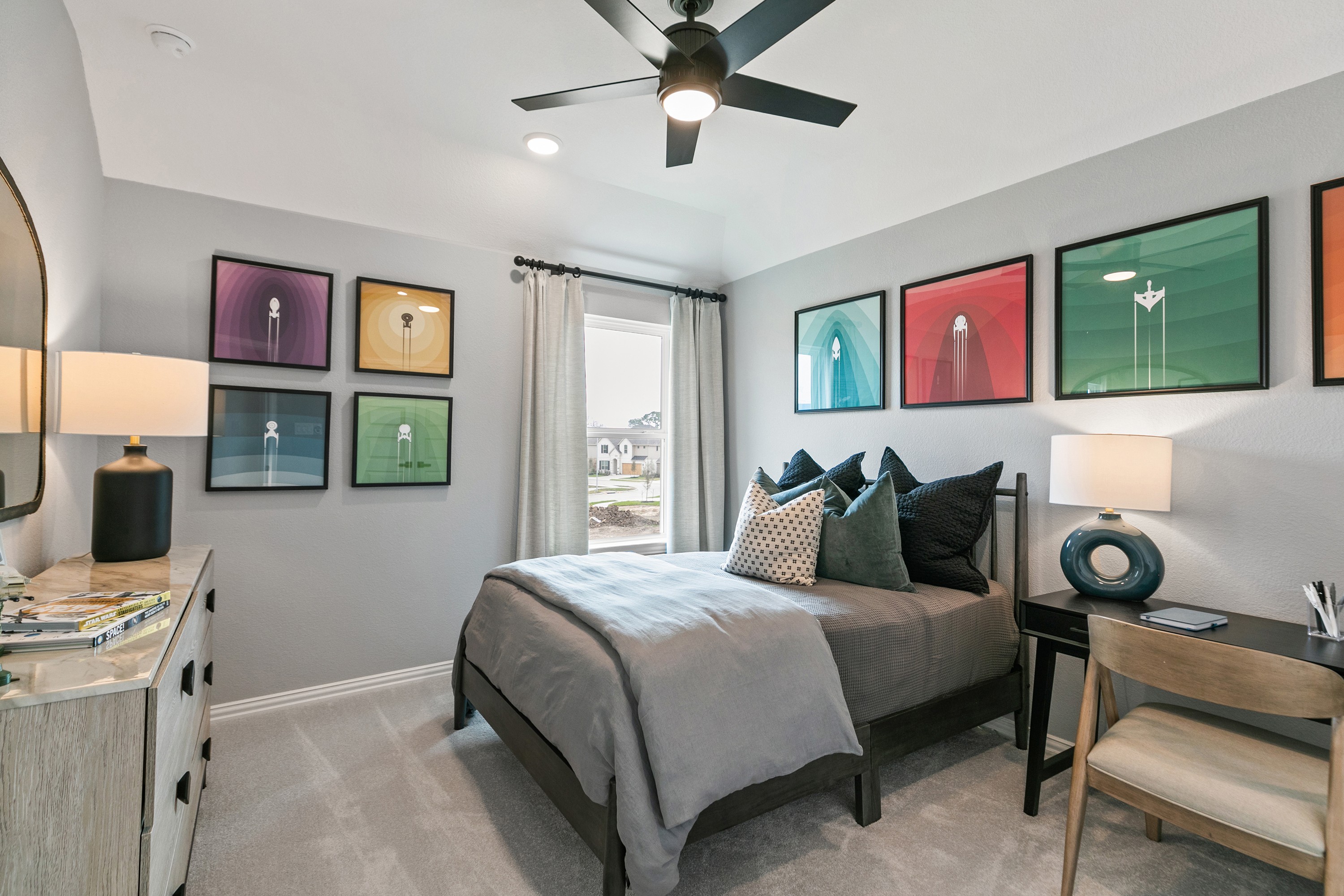 Modern bedroom with abstract art, sleek ceiling fan, natural light, Park at Eldridge community, luxury real estate.