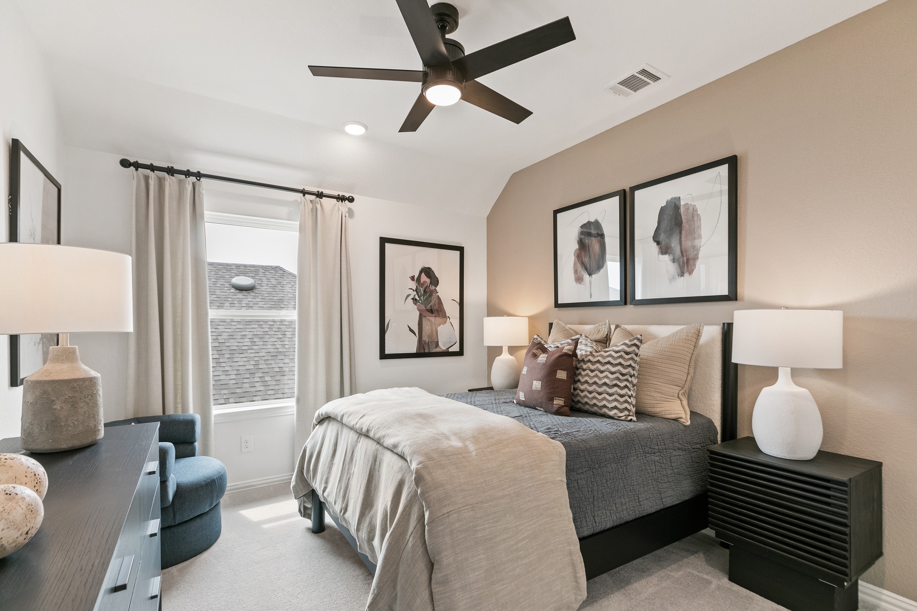 Modern bedroom with beige accent wall, abstract art, plush bedding, at Park at Eldridge community.