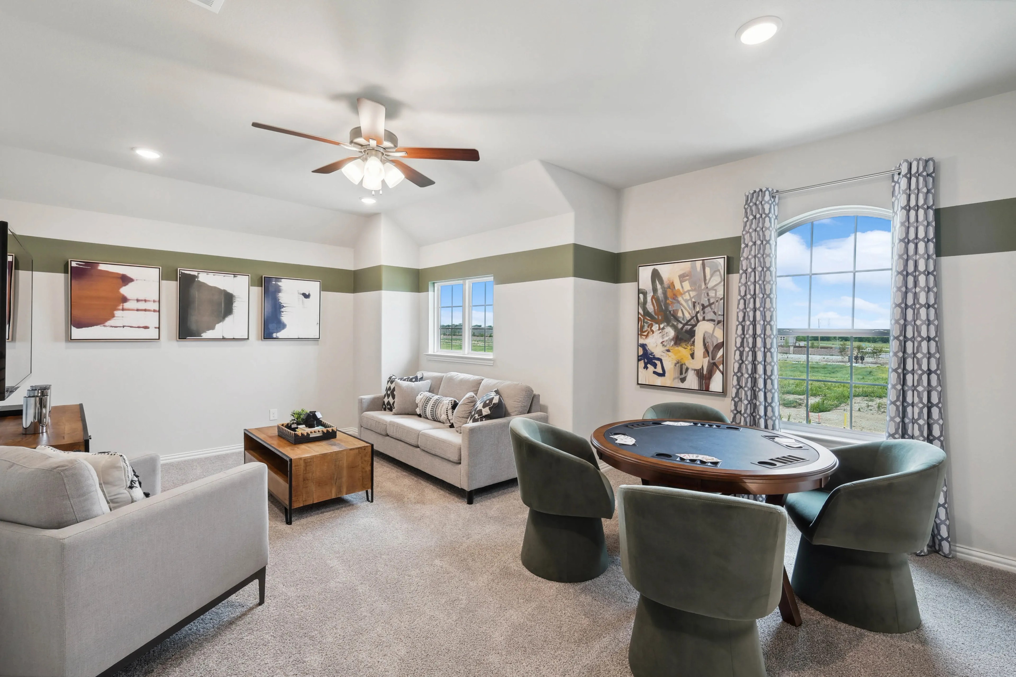 Elegant game room with modern decor, poker table, abstract art, large window views in Hulen Trails, Texas.