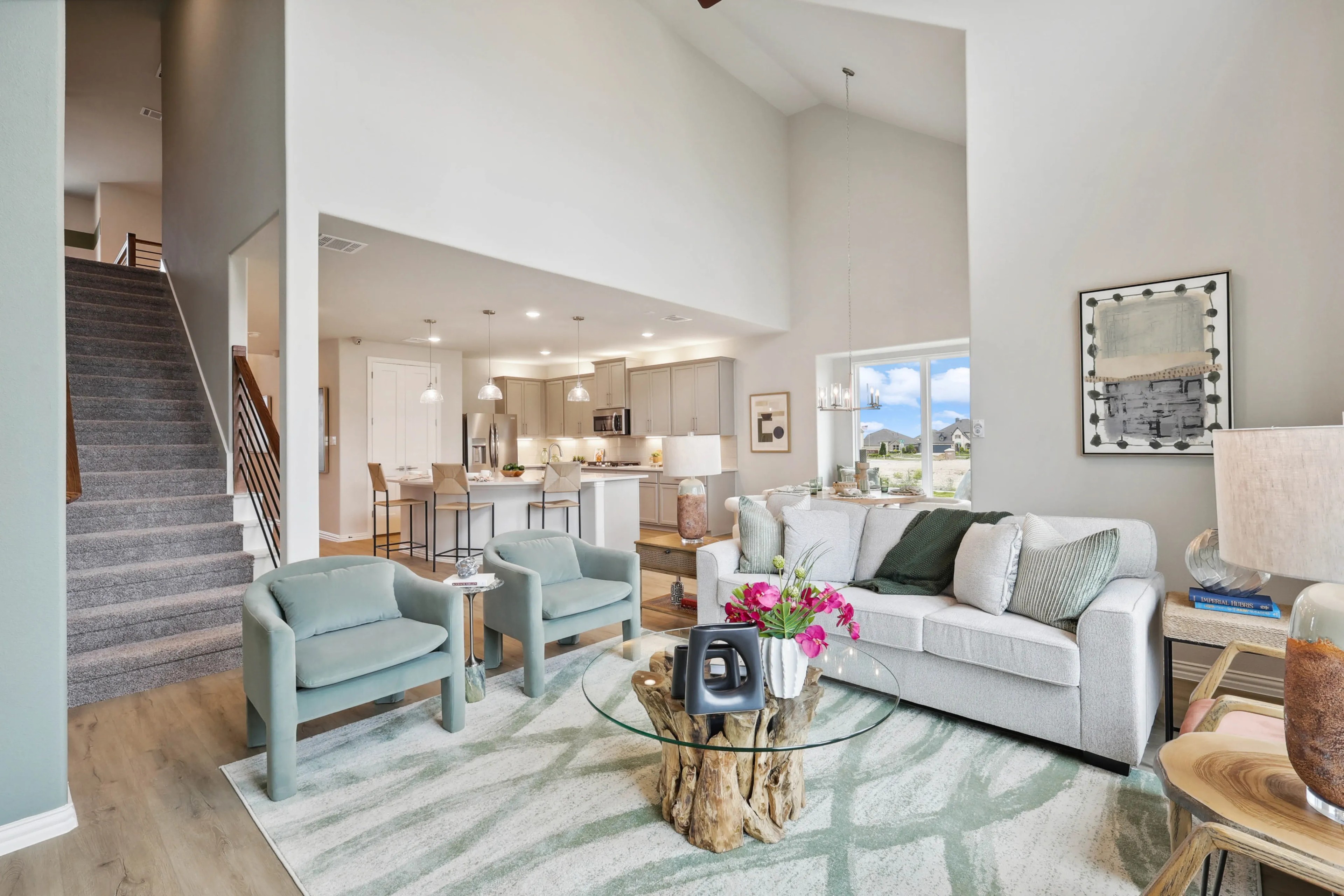 Modern living room with open kitchen, high ceilings, and large windows in Hulen Trails, Texas.