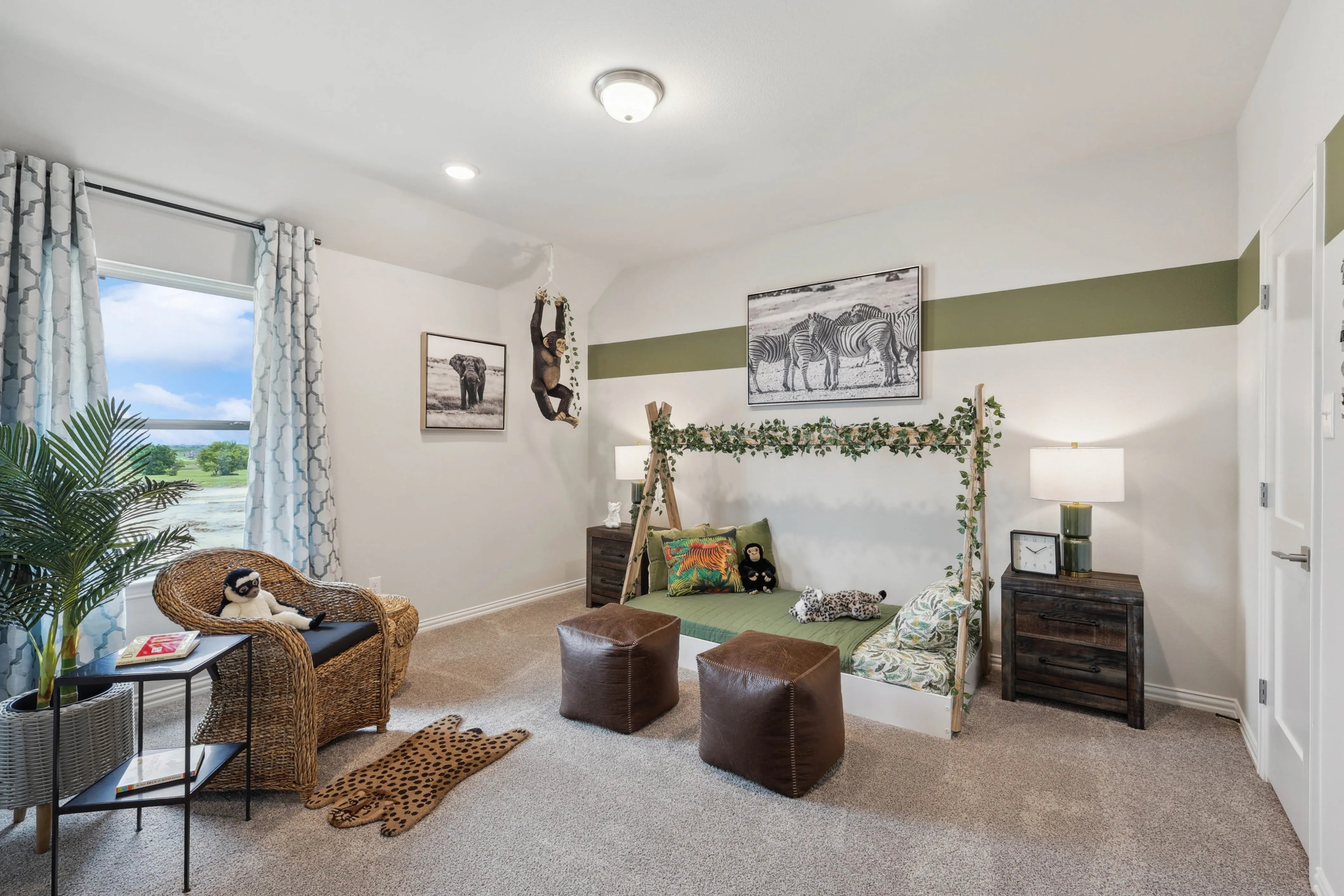 Children’s room with safari theme and nature decor, located in Hulen Trails. Features wicker chair, leafy frame.