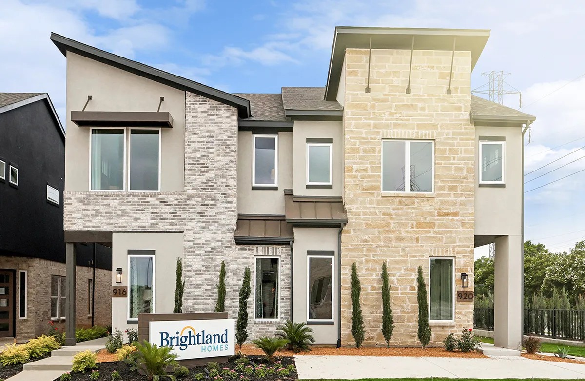 Modern Collin Creek home featuring mixed brick and stone facade with large windows, located in desirable Texas community.