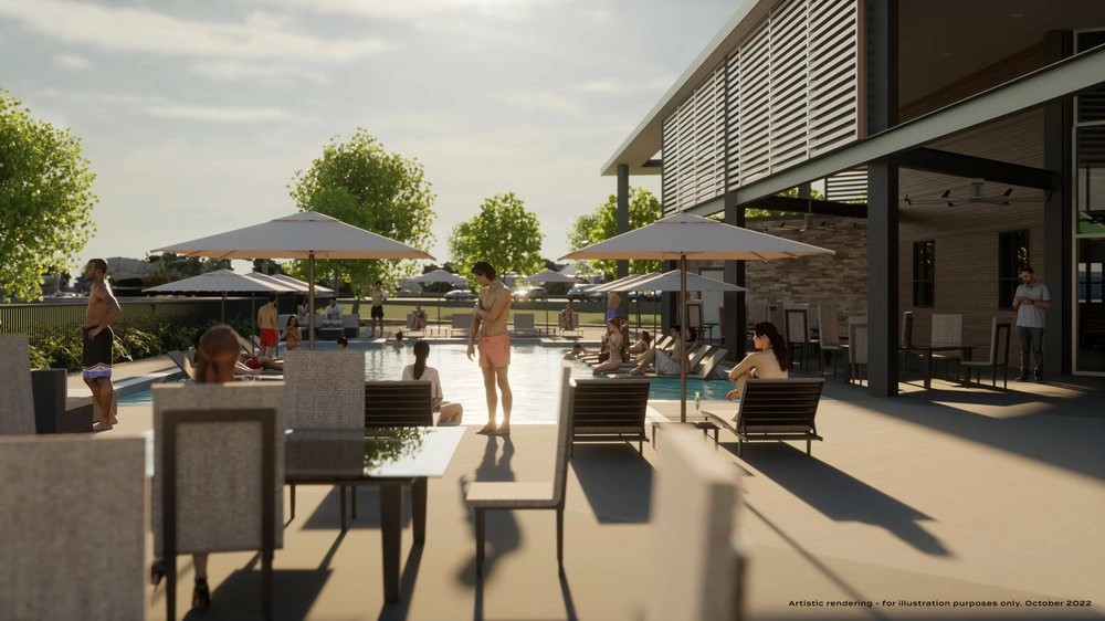 Luxurious poolside with loungers, large umbrellas, modern clubhouse, and lush trees at Collin Creek community.