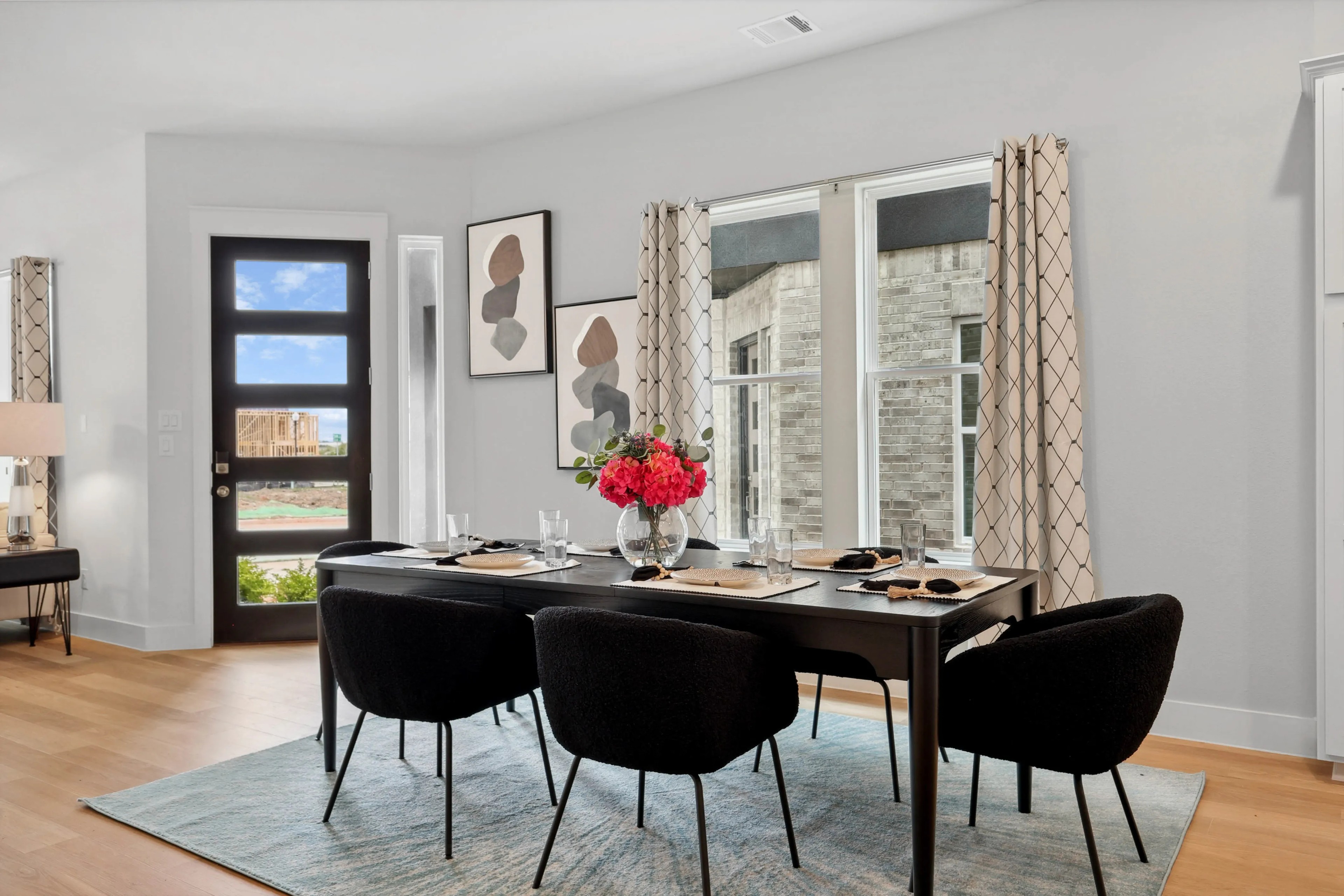 Elegant dining room with modern furniture, natural light, abstract art in Collin Creek.