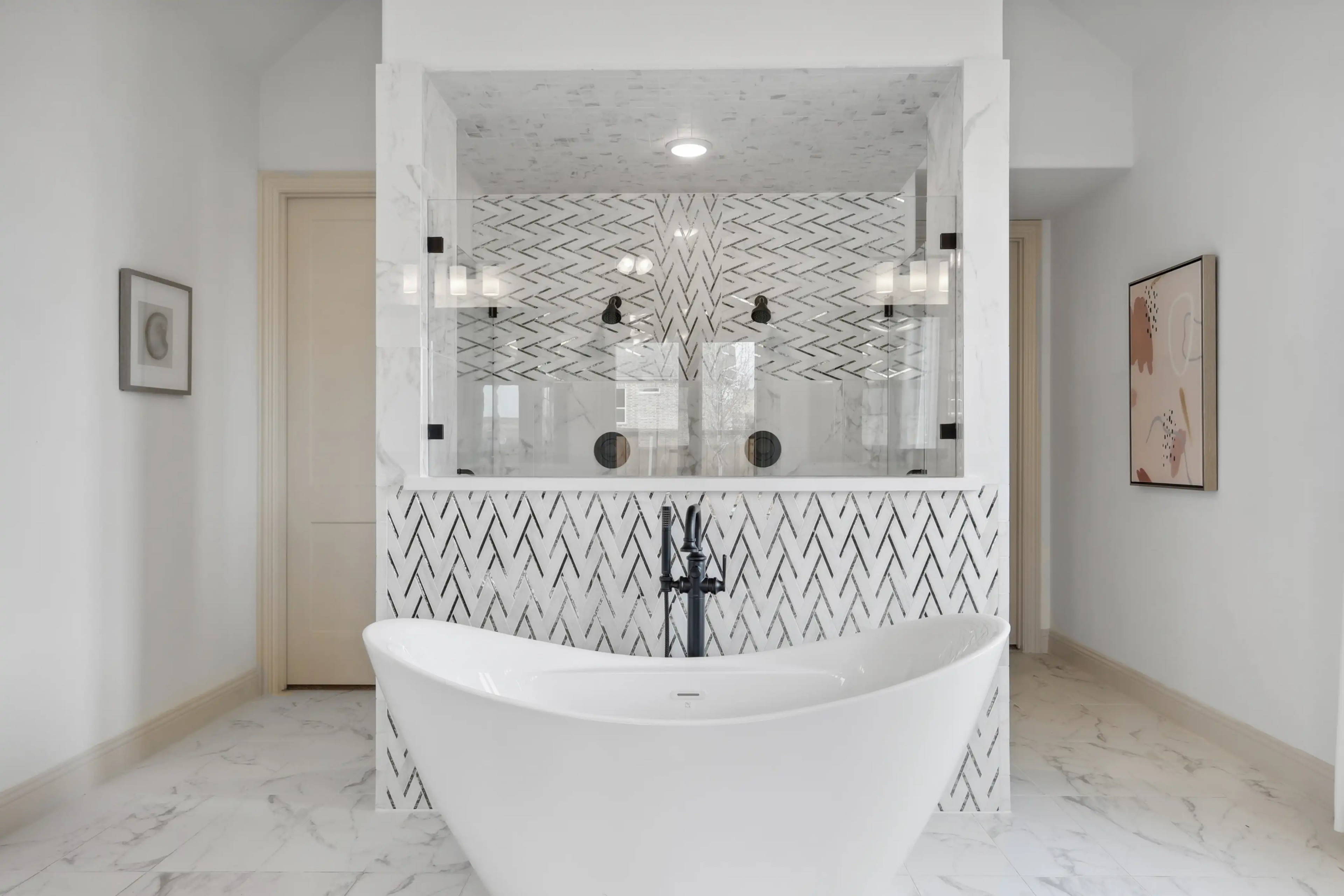 Luxurious bathroom in Westside Preserve, features freestanding tub, herringbone tile, and marble details.
