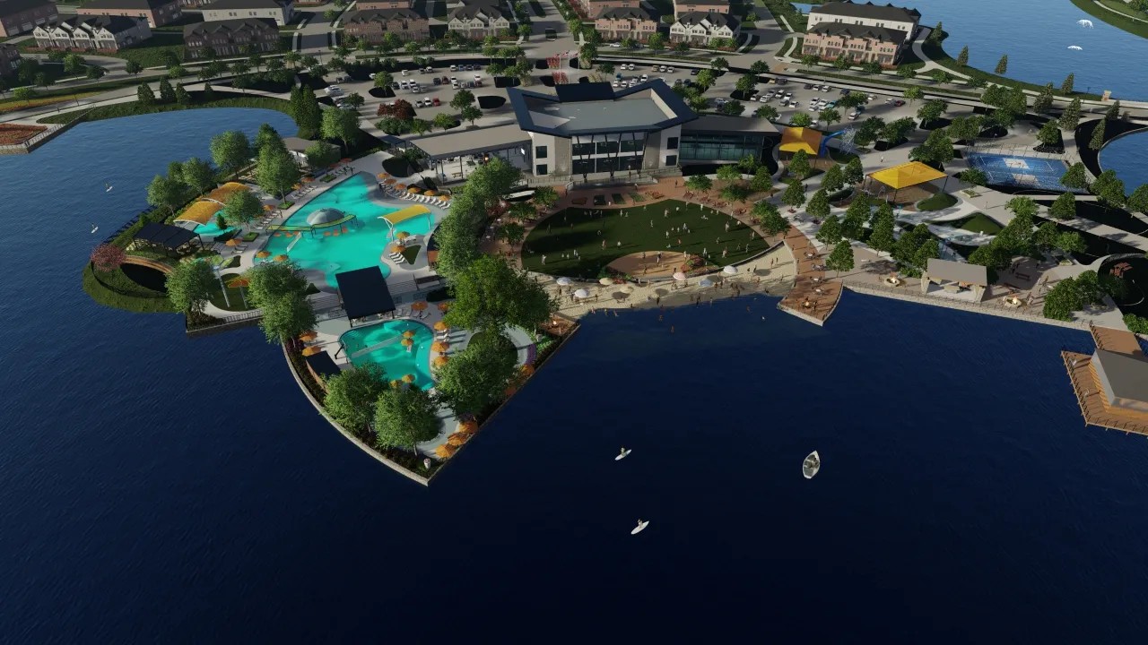 Aerial view of Solterra Texas community, showcasing a modern clubhouse, pools, and landscaped waterfront area.