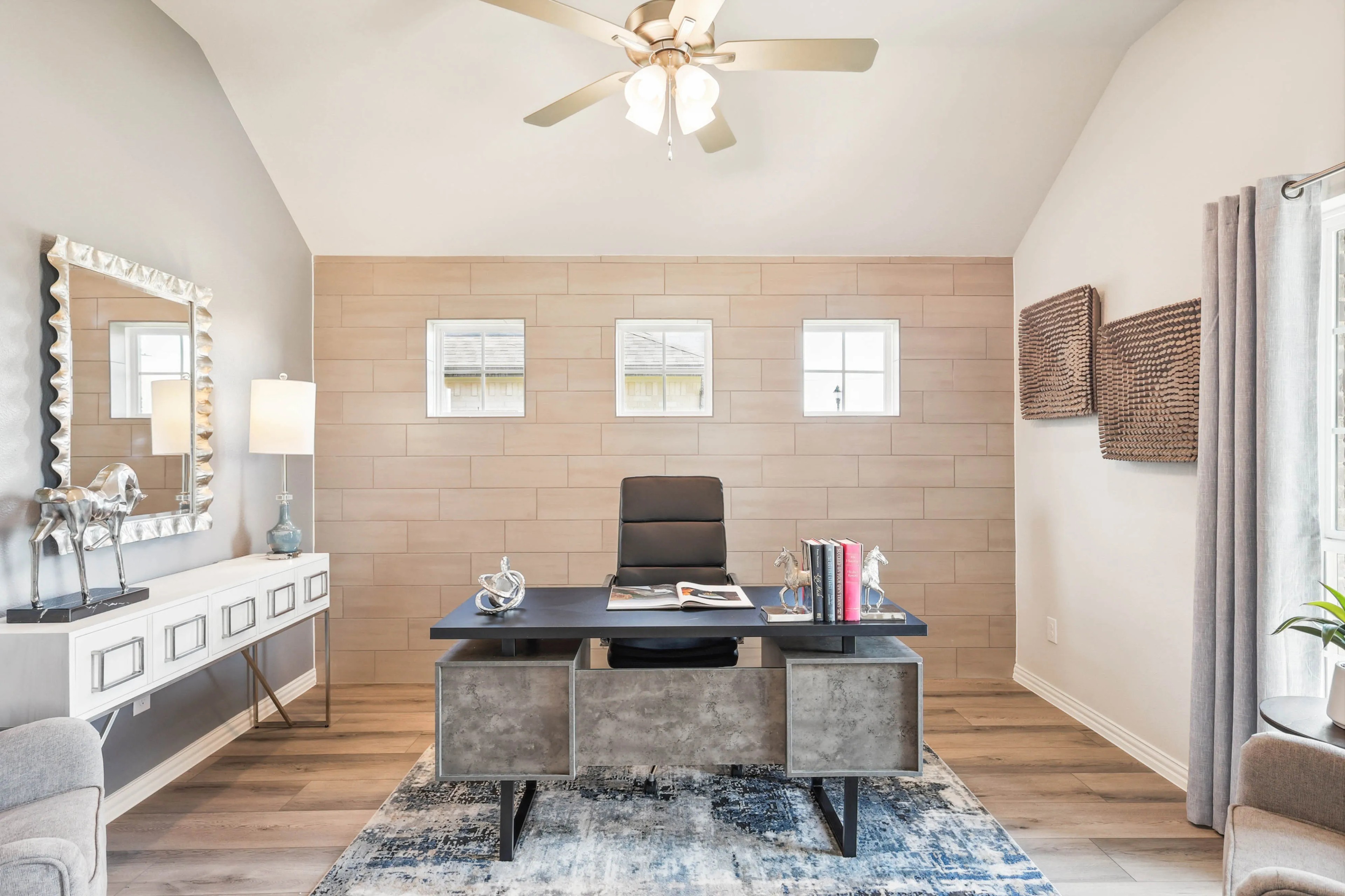 Luxurious home office with beige accent wall, modern desk, and natural light in Pebblebrook community.