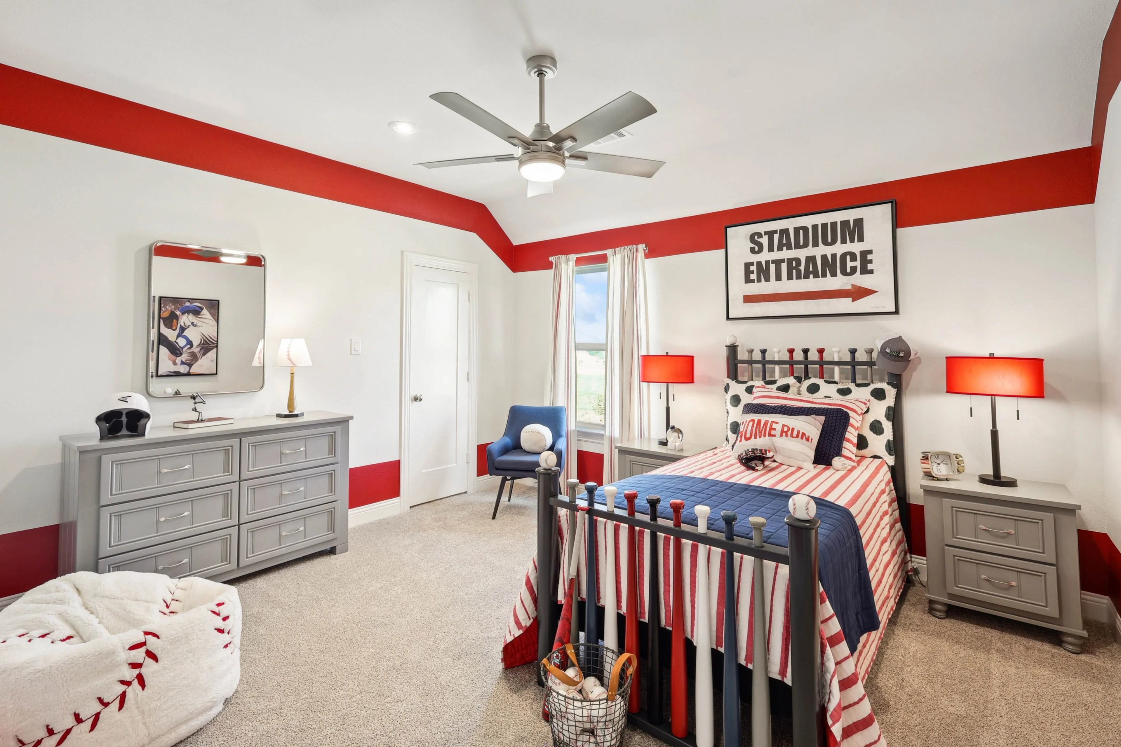 Baseball-themed bedroom, vibrant red accents, modern ceiling fan, Ridge Crossing community location, sporty decor.