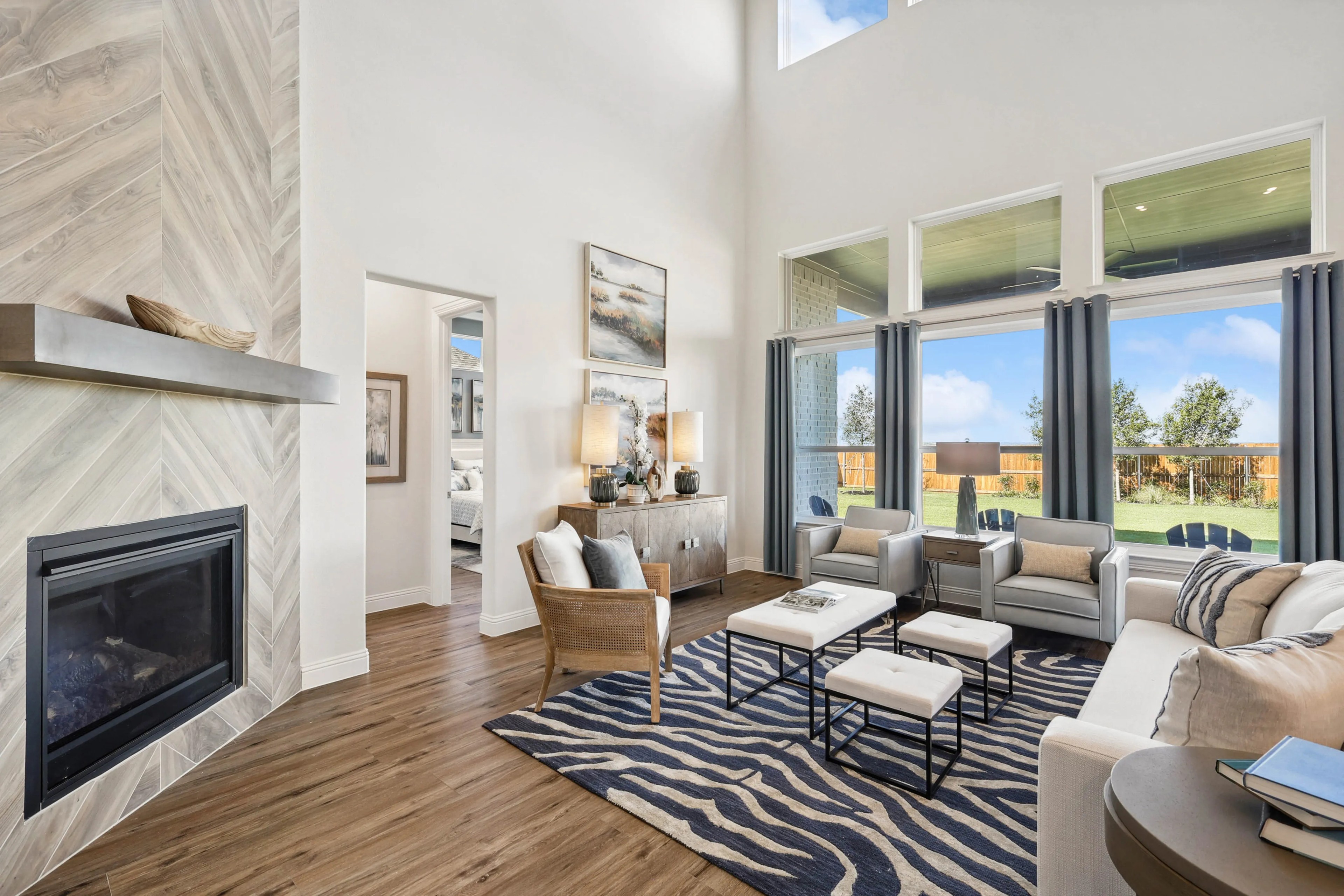 Spacious Ridge Crossing living room, high ceiling, large windows, stylish fireplace, elegant modern decor, Texas.