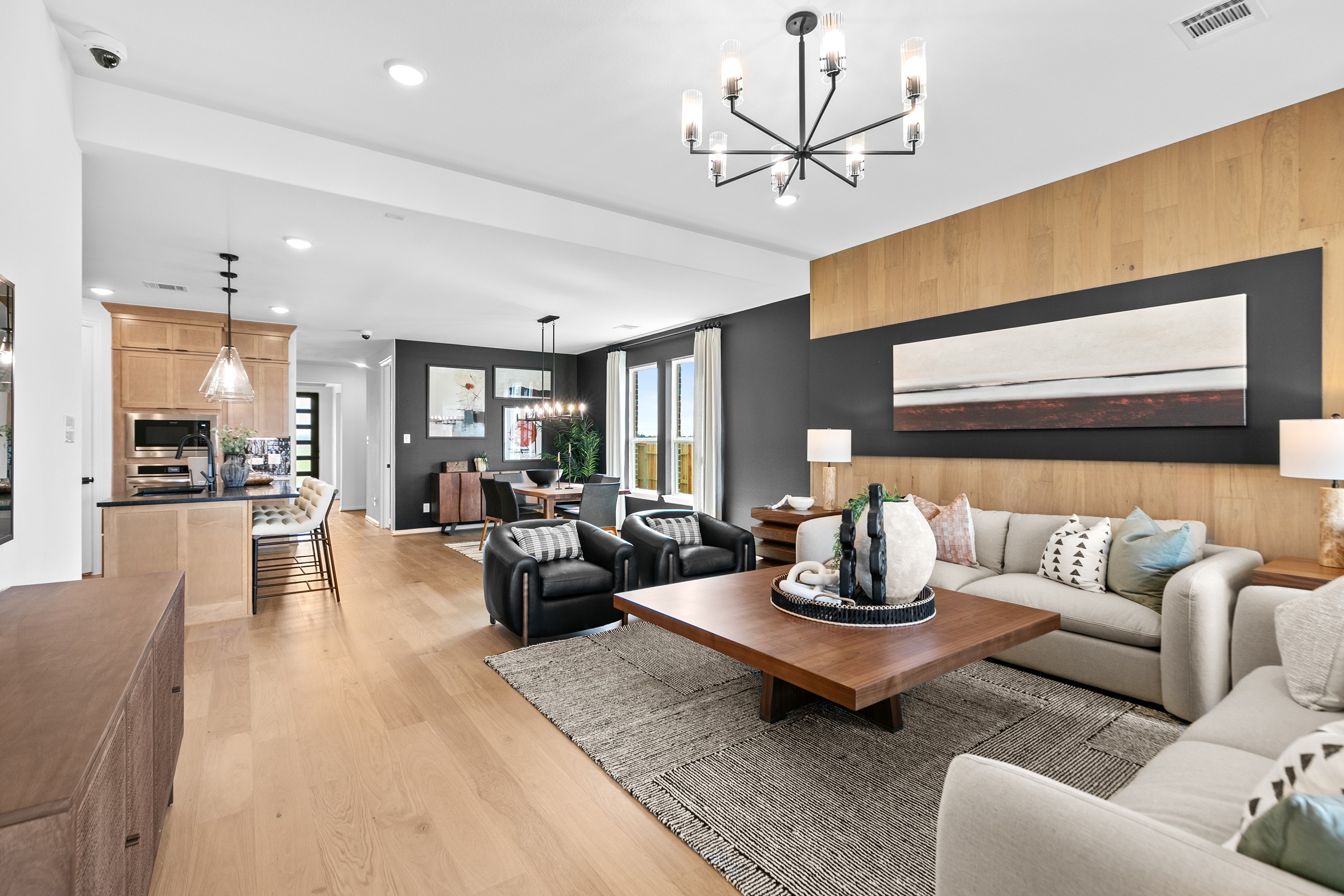 Luxurious modern living room in River Ranch with wood accents, elegant lighting, and open layout. Dining area visible.