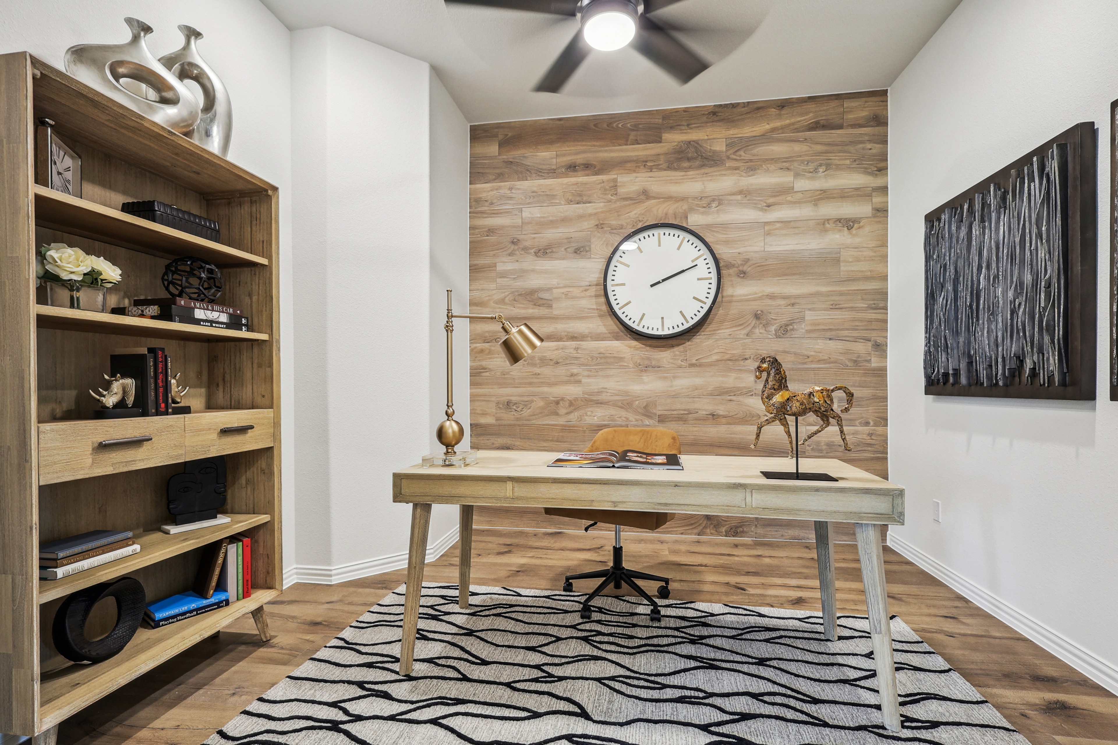 Elegant home office with wood accent wall, modern decor, and shelving. Churchill area real estate.