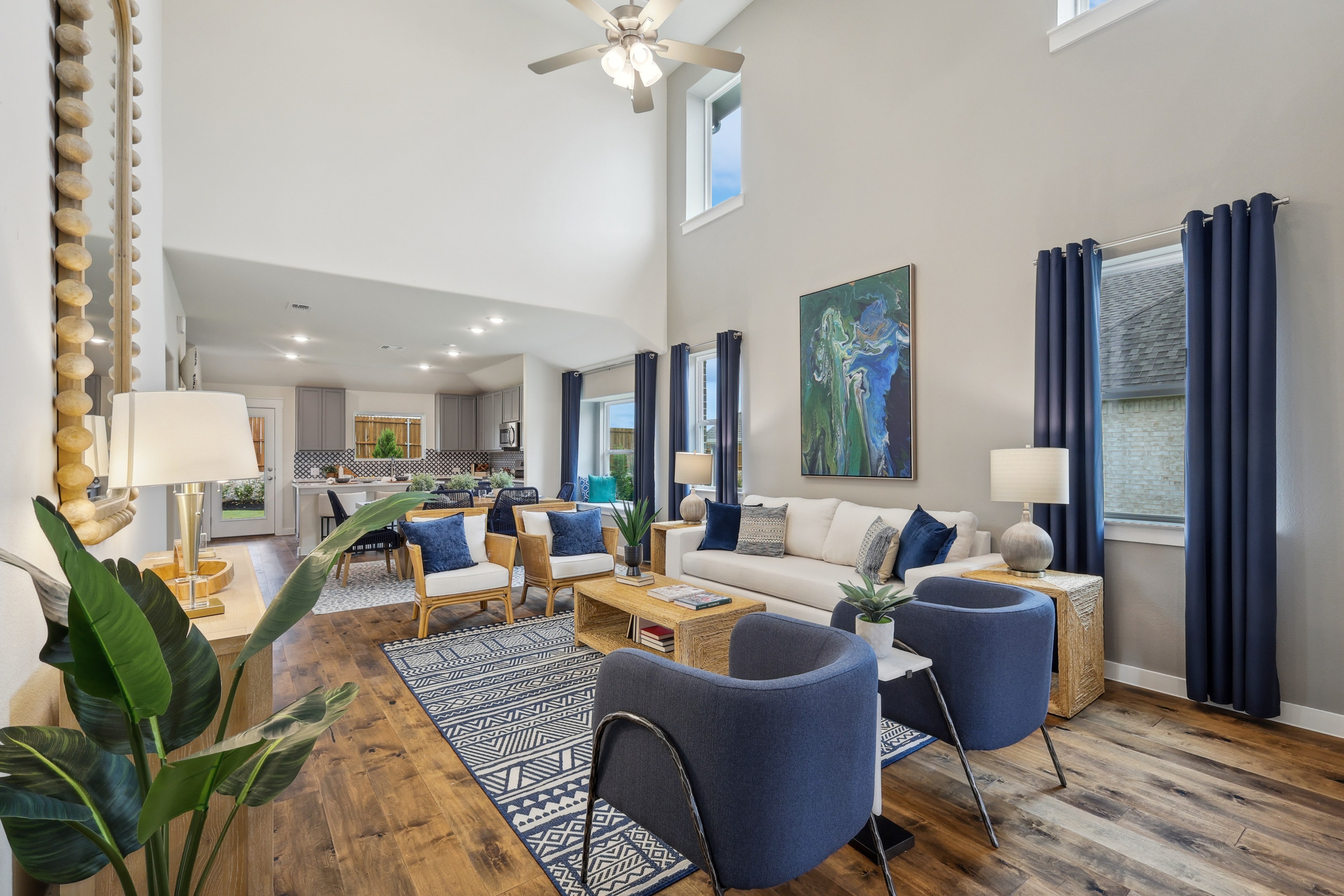 Spacious living room with vaulted ceiling, wood floors, modern furniture, in Churchill community.