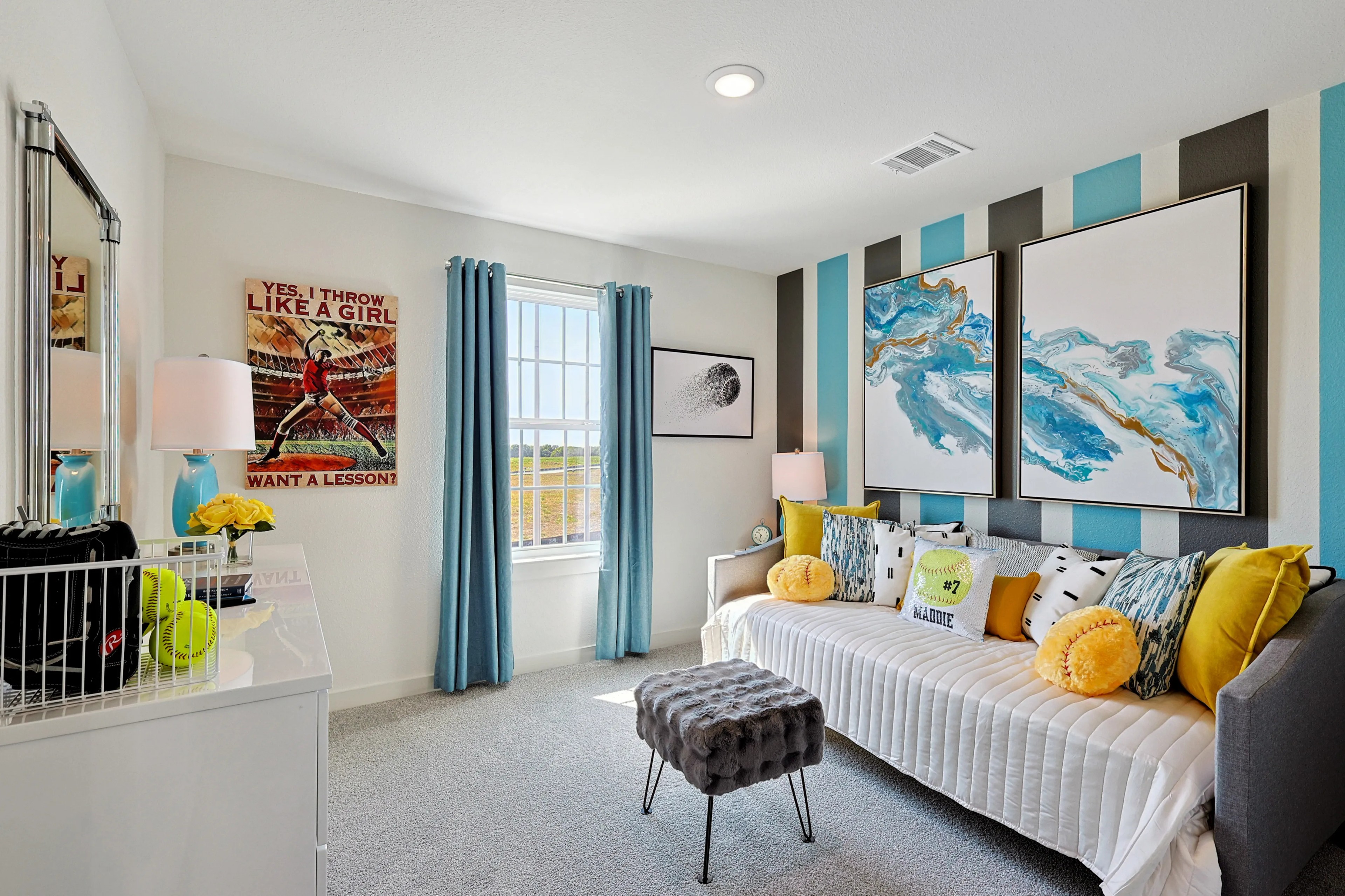 Chic kids' room with striped accent wall, textured art, and soft natural light in Patriot Estates.
