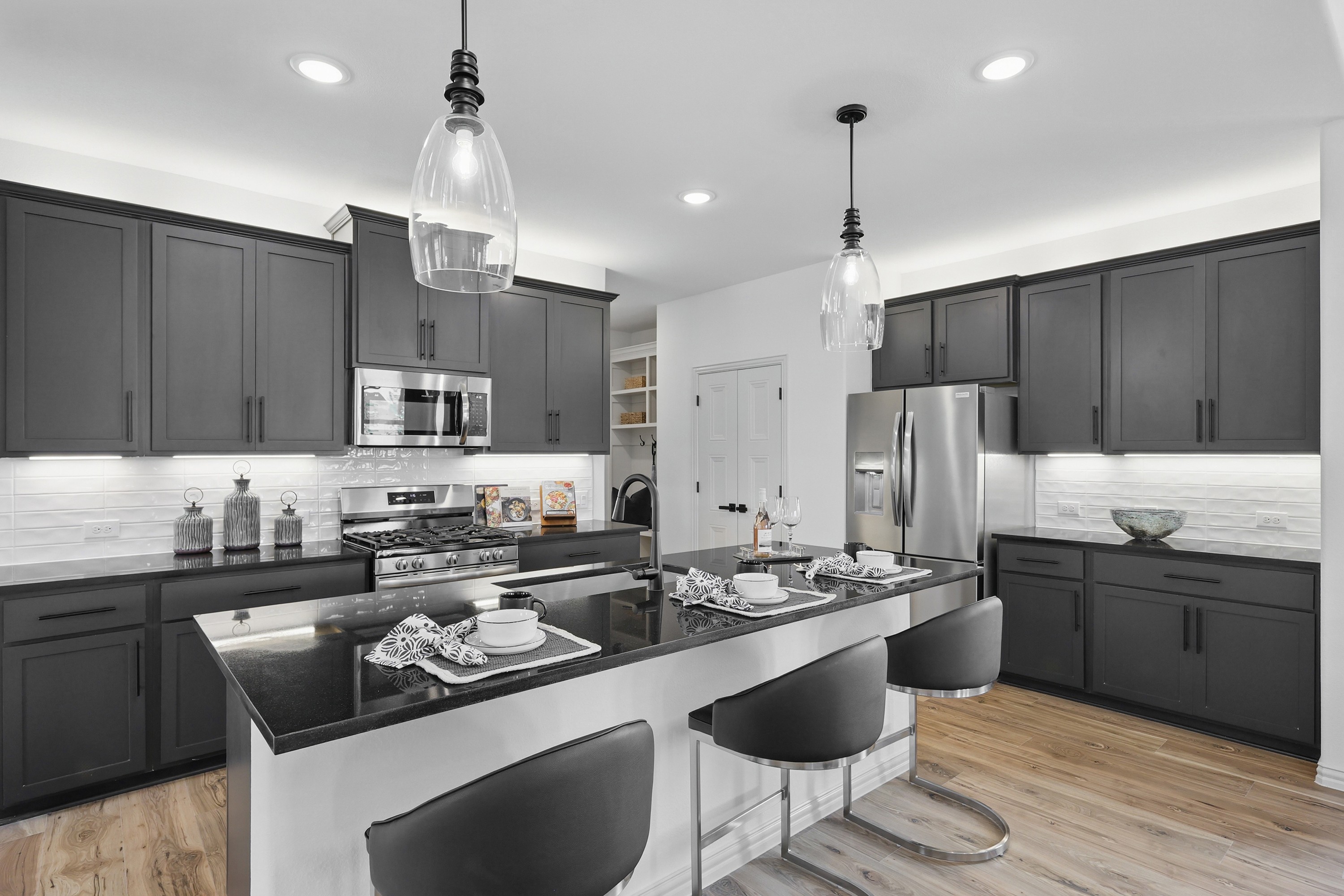 Modern kitchen with dark cabinets, stainless steel appliances, pendant lights, Westridge.