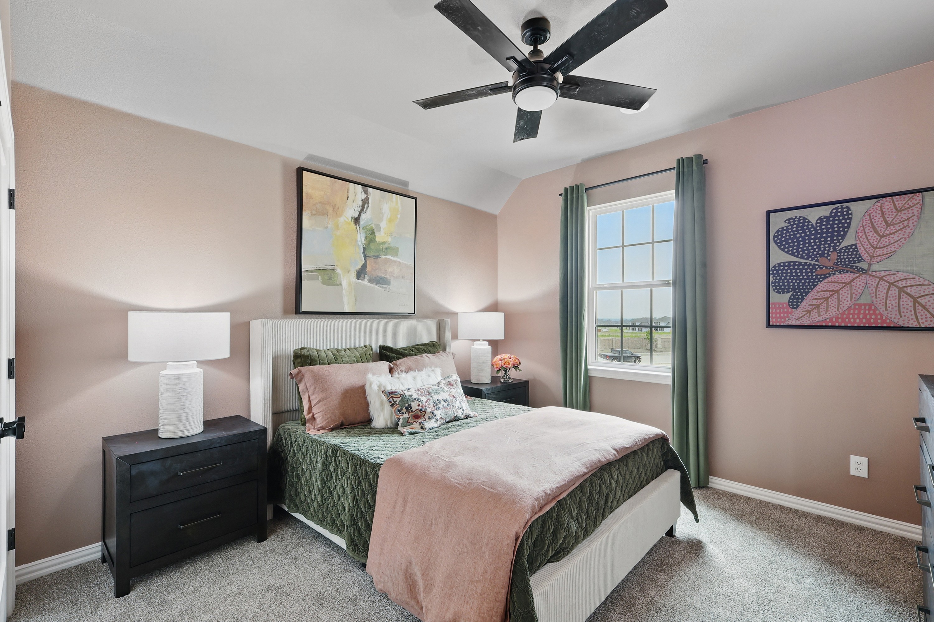 Bedroom with elegant decor, featuring modern ceiling fan, large window, and wall art in Westridge community.