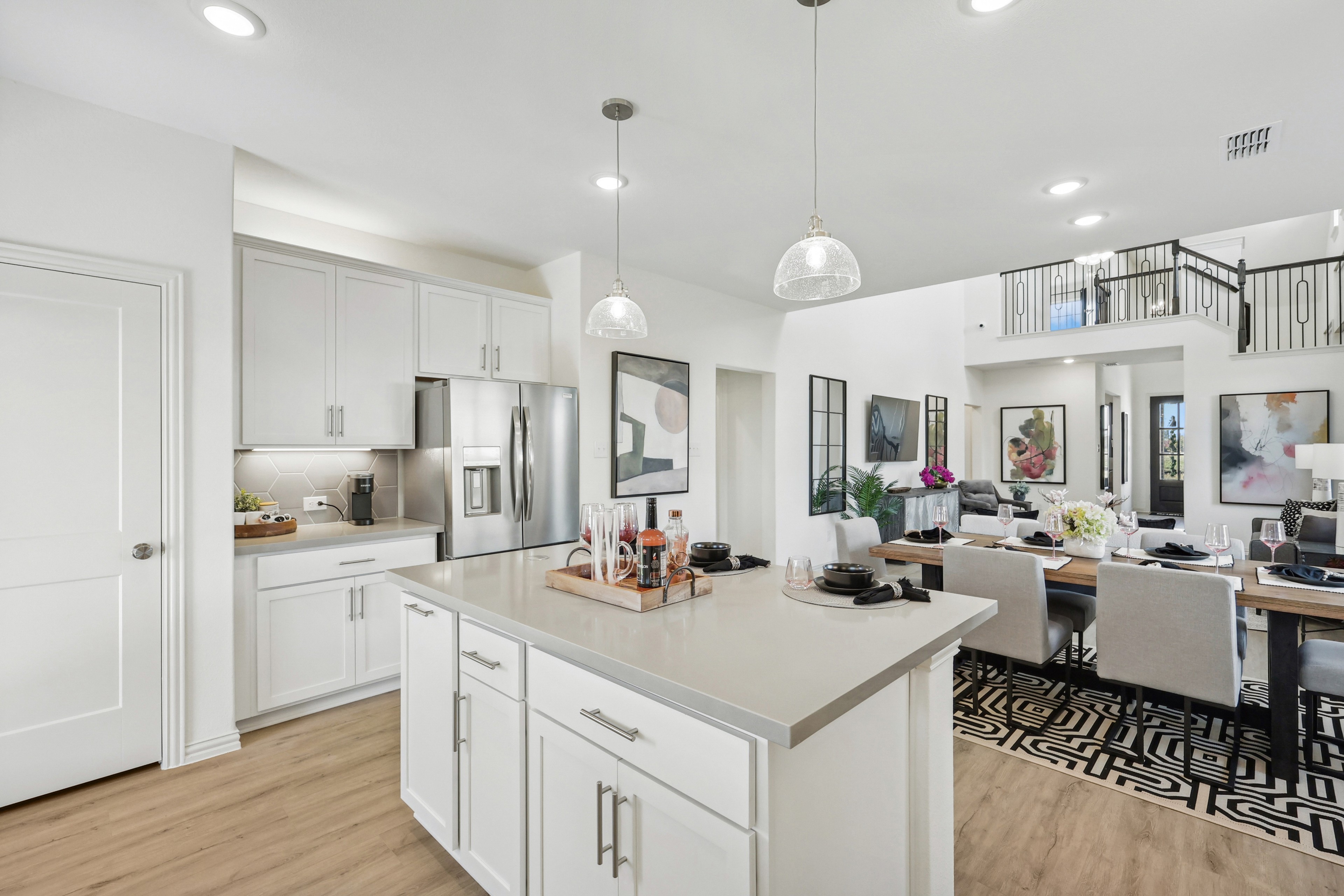 Modern kitchen with island, stainless steel appliances, and open dining area in Bel Air Village.