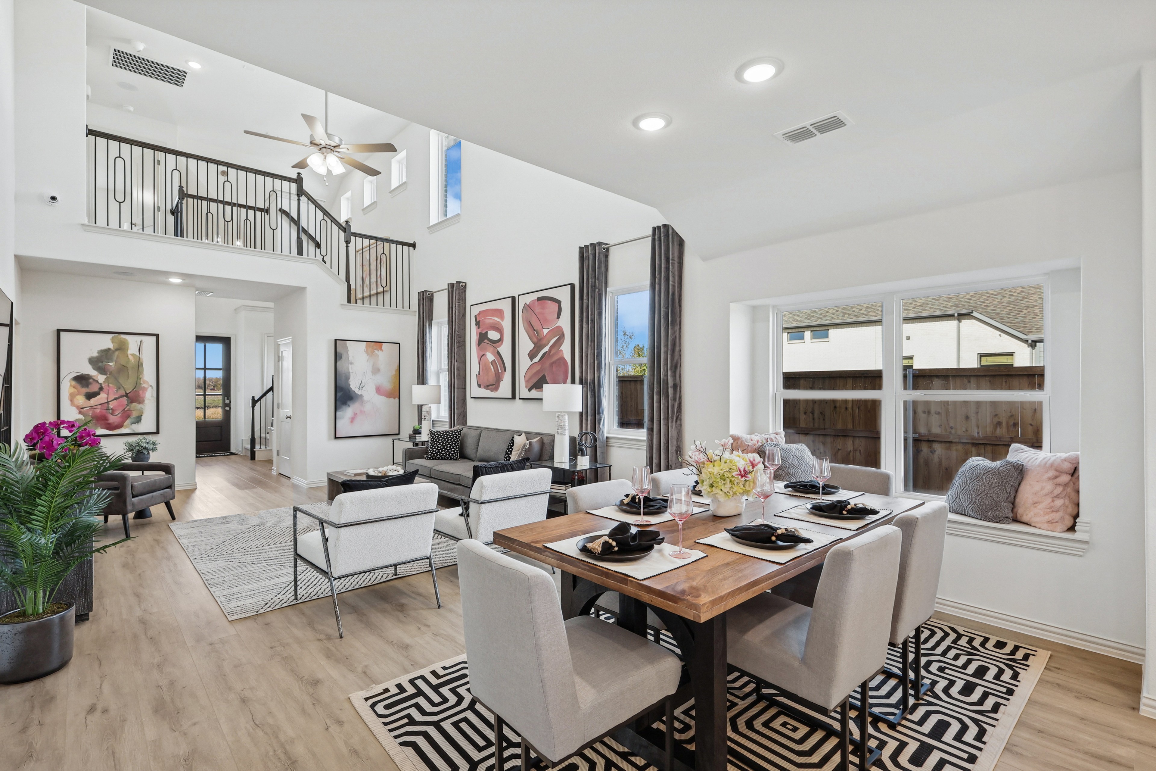 Luxurious living-dining area with modern decor, high ceilings, and large windows in Bel Air Village.