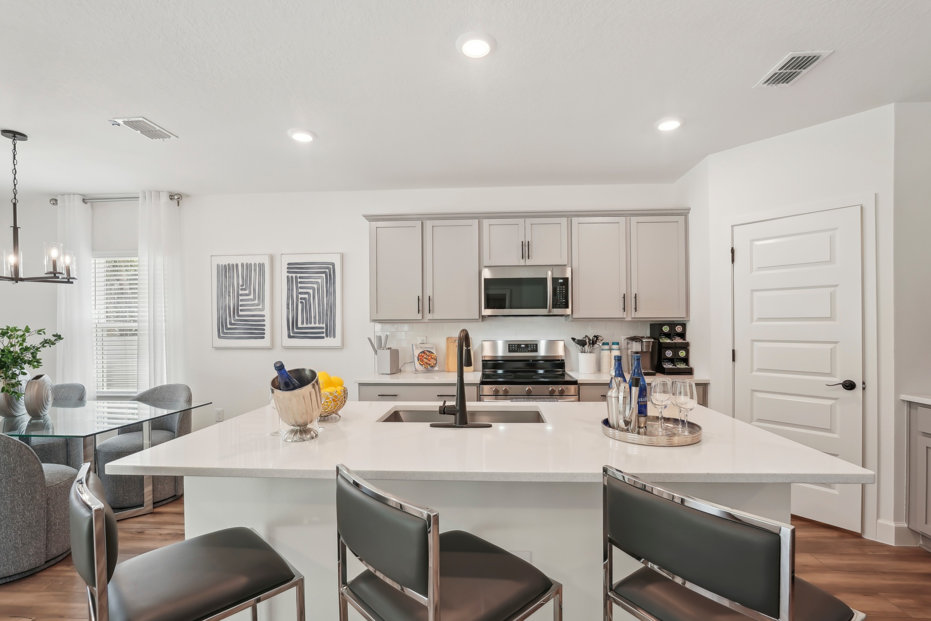 Modern North Port kitchen with quartz island, stainless steel appliances, and elegant decor.