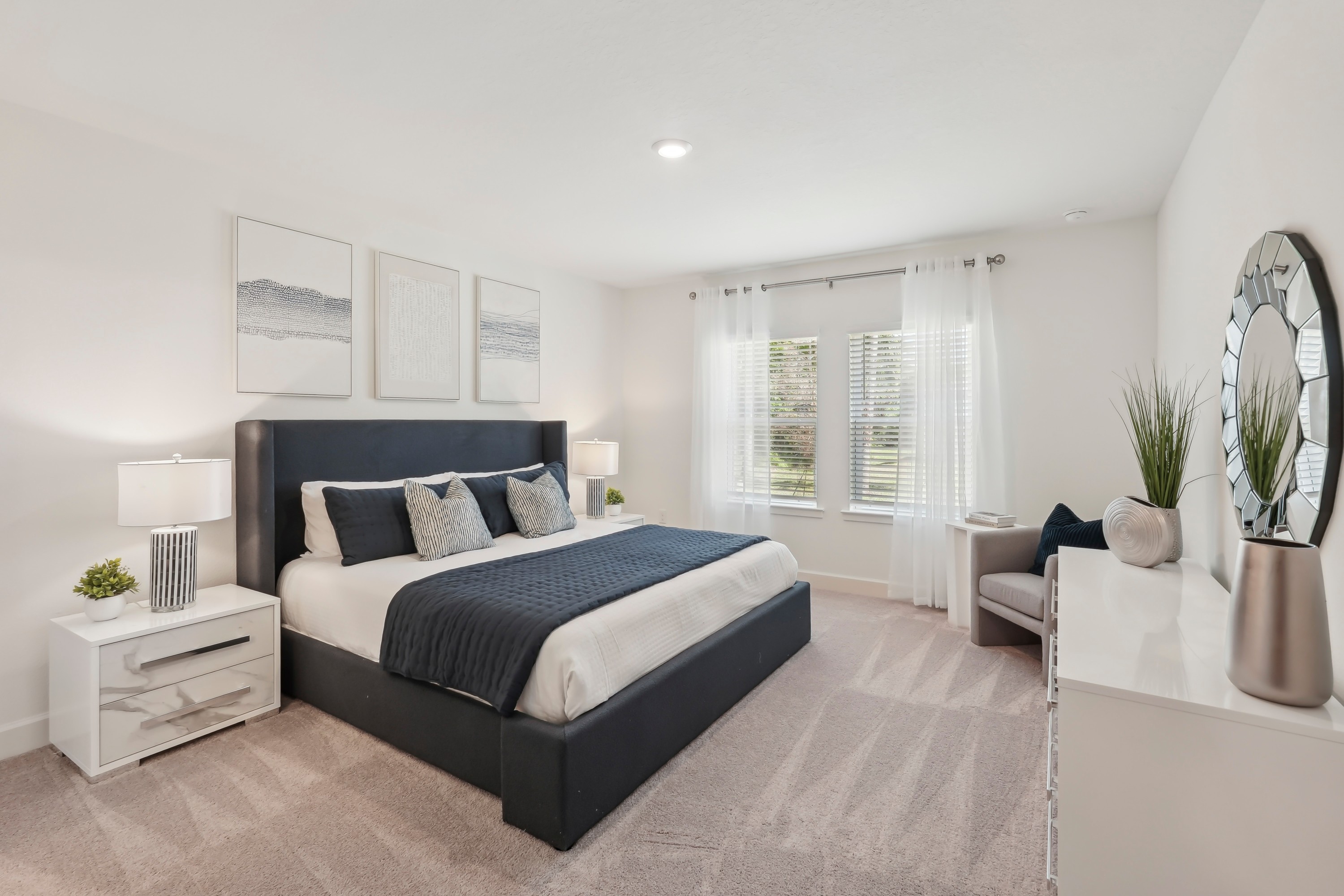 Elegant bedroom with large window, navy accents, and contemporary decor in North Port.
