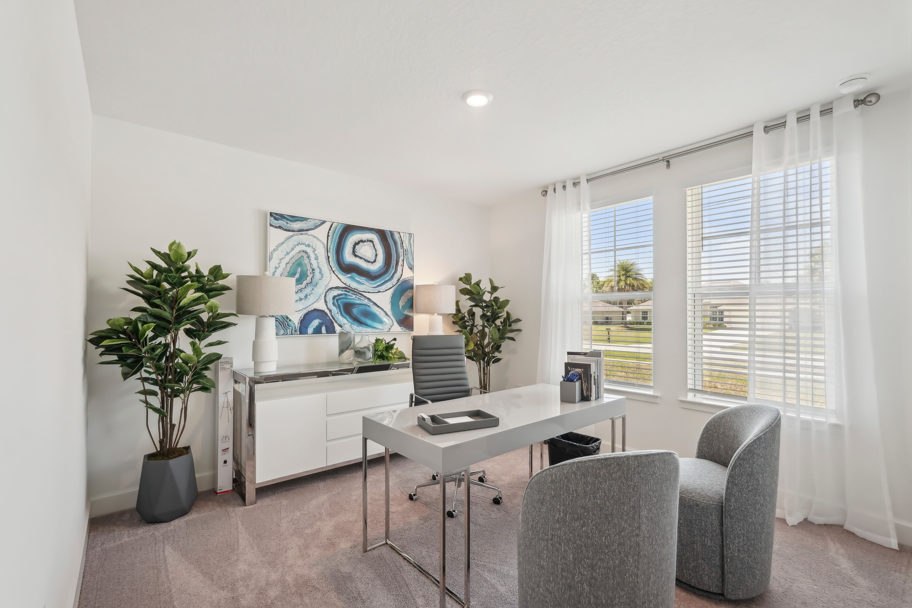 Modern home office with large windows, sleek desk, abstract art, in North Port.