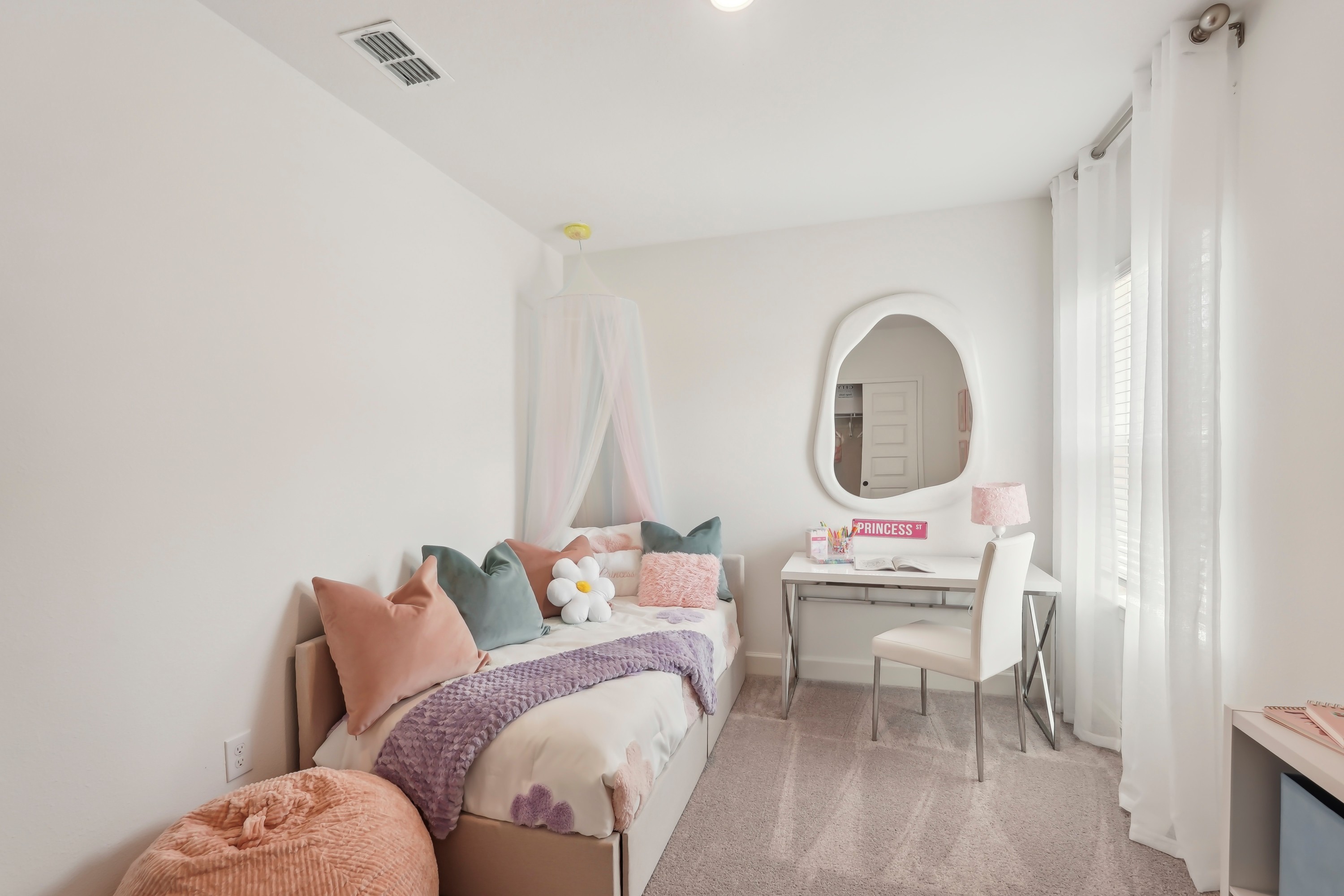 Elegant kids' bedroom with pastel decor, North Port; features canopy bed, modern desk.