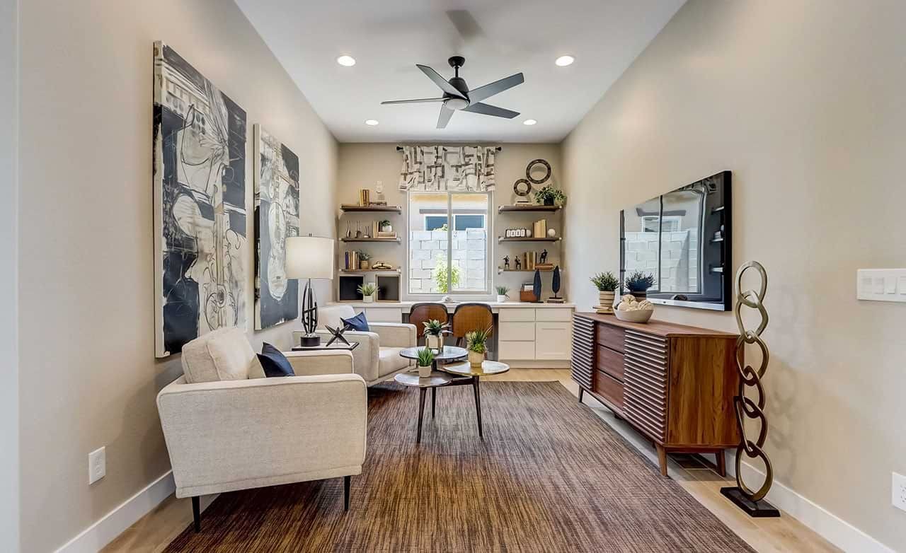 Elegant living room with abstract art, modern fan, Canyon Views, Hacienda community.