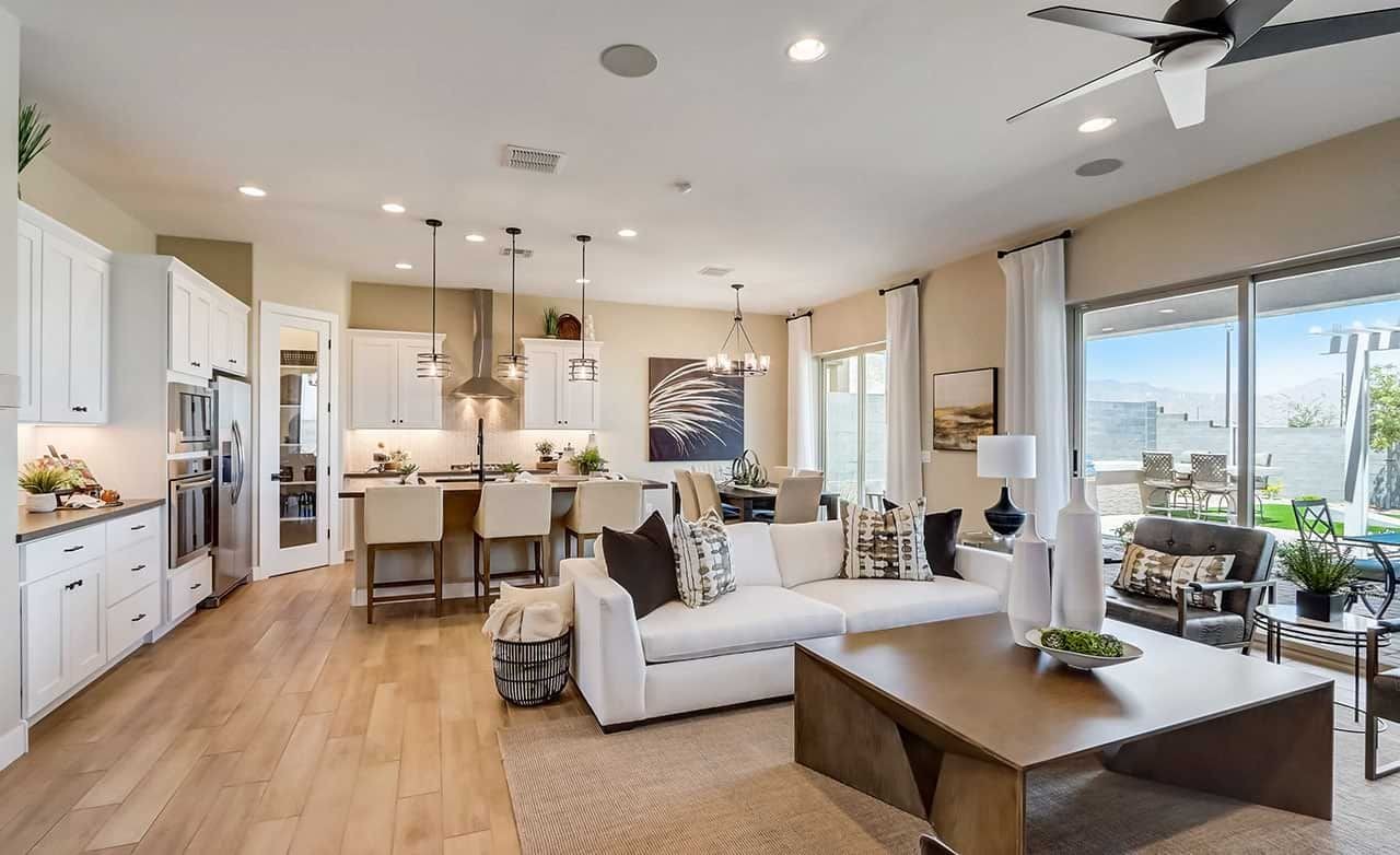 Spacious living room with modern decor, hardwood floors, open kitchen, large windows in Hacienda.