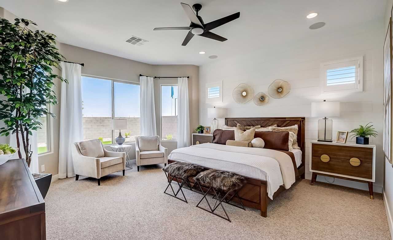 Luxurious bedroom with modern decor, large windows, natural light, neutral tones in Hacienda community.