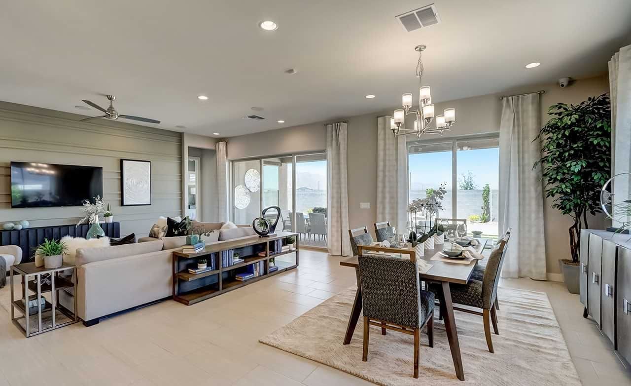 Elegant modern living and dining area with panoramic canyon views, large windows, and luxurious decor in Hacienda community.