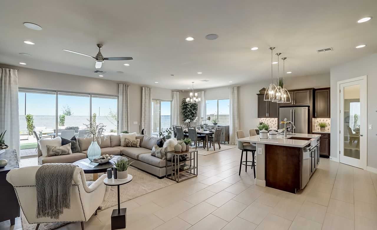 Spacious open-plan living area with modern kitchen, large sofa, dining table, ceiling fan, Arizona.