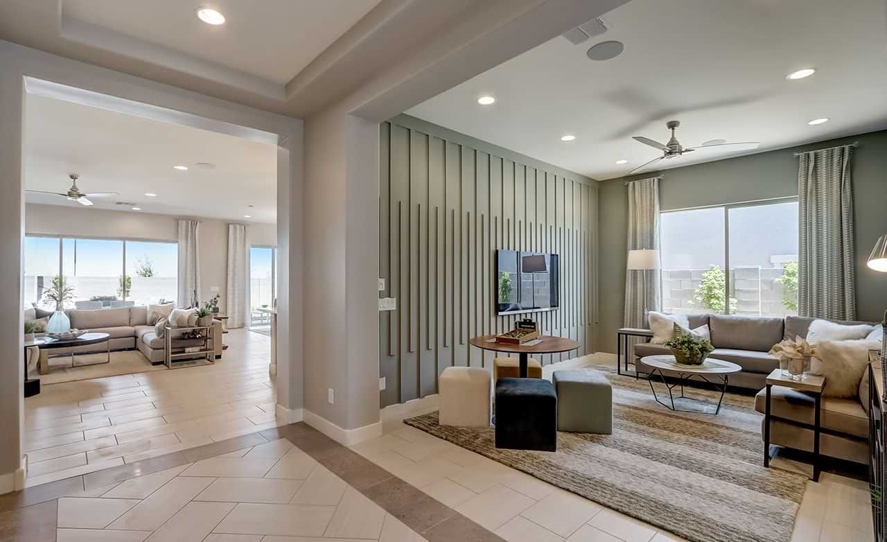Modern living room and lounge with large windows, light neutral tones, and sleek ceiling in Canyon Views-Hacienda community.