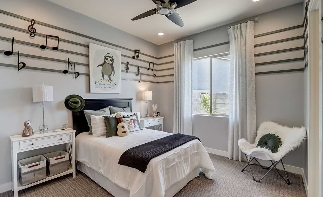 Music-themed bedroom with musical note decor, modern furniture, large window, Canyon Views Hacienda community.