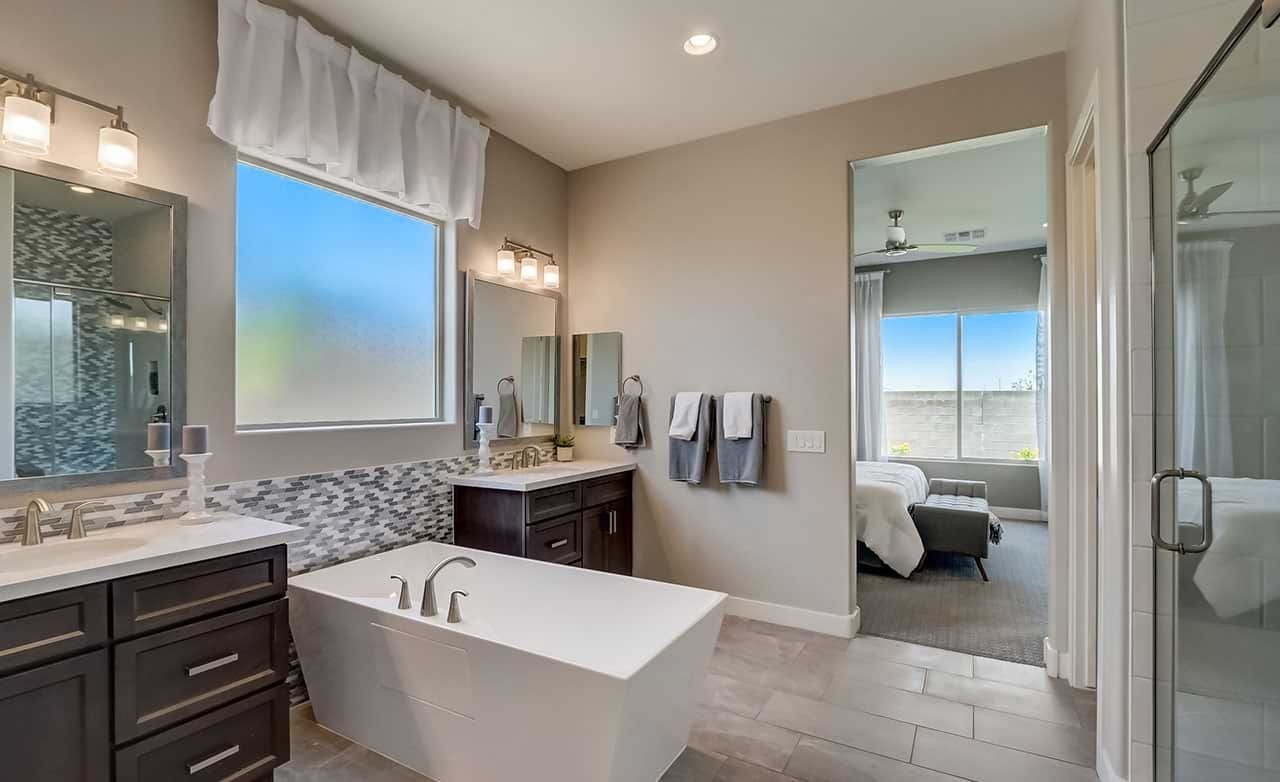 Modern bathroom with sleek fixtures, dark wood cabinetry, freestanding tub in Hacienda community home.