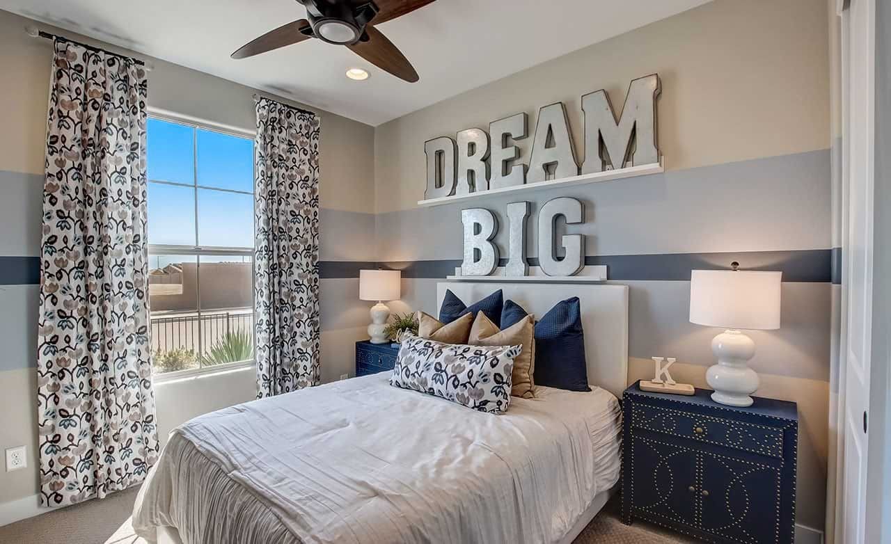 Chic bedroom with large "Dream Big" sign, plush bedding, and stylish decor, Castillo at Anderson Parc, Arizona.