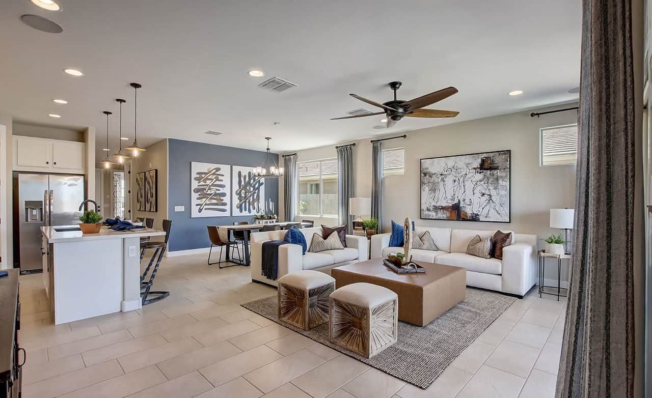 Modern open living room in Castillo at Anderson Parc with elegant decor, pendant lights, and large windows.
