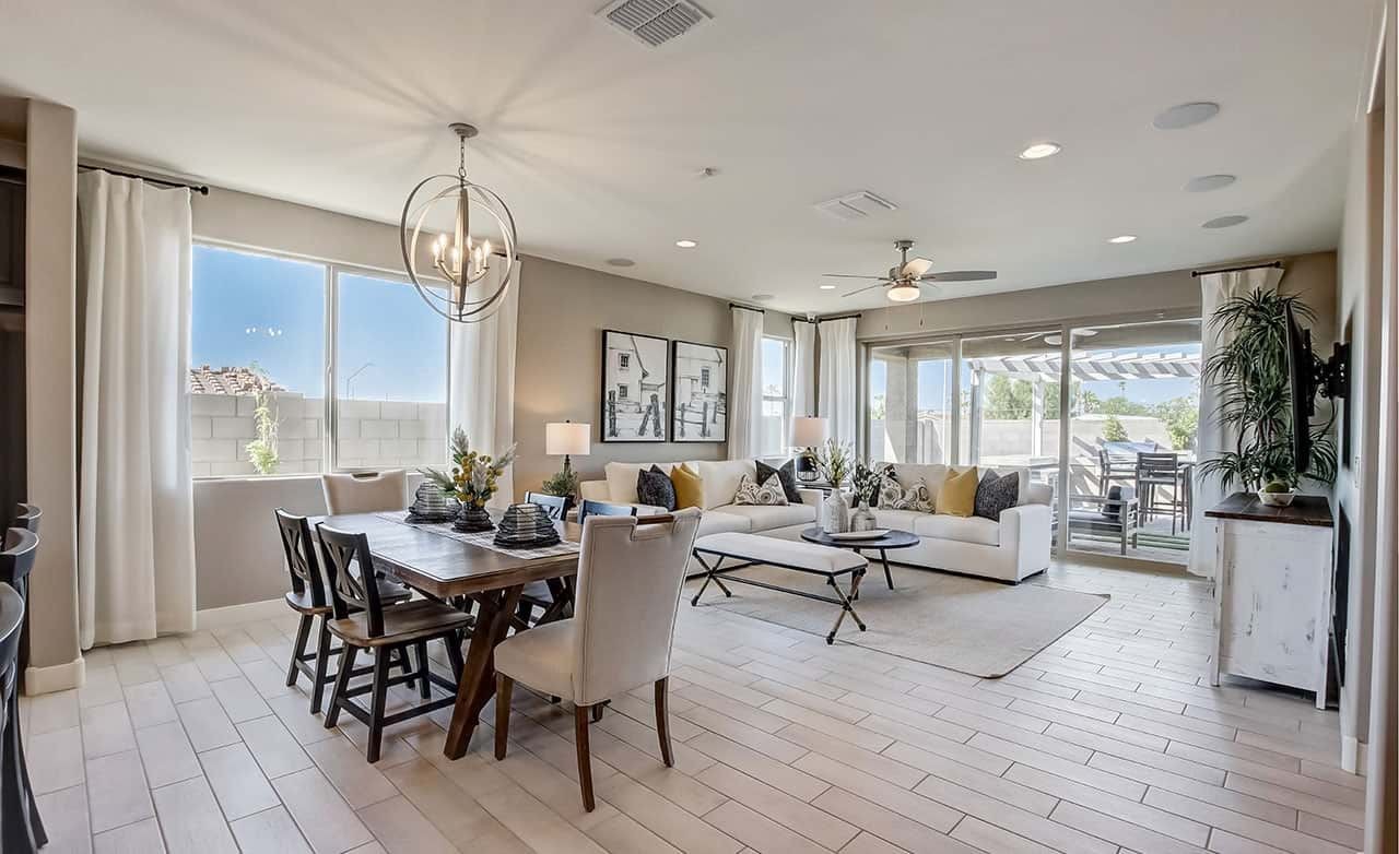Luxurious open-plan living room with dining area, stylish lighting, and patio view in Anderson Parc home.