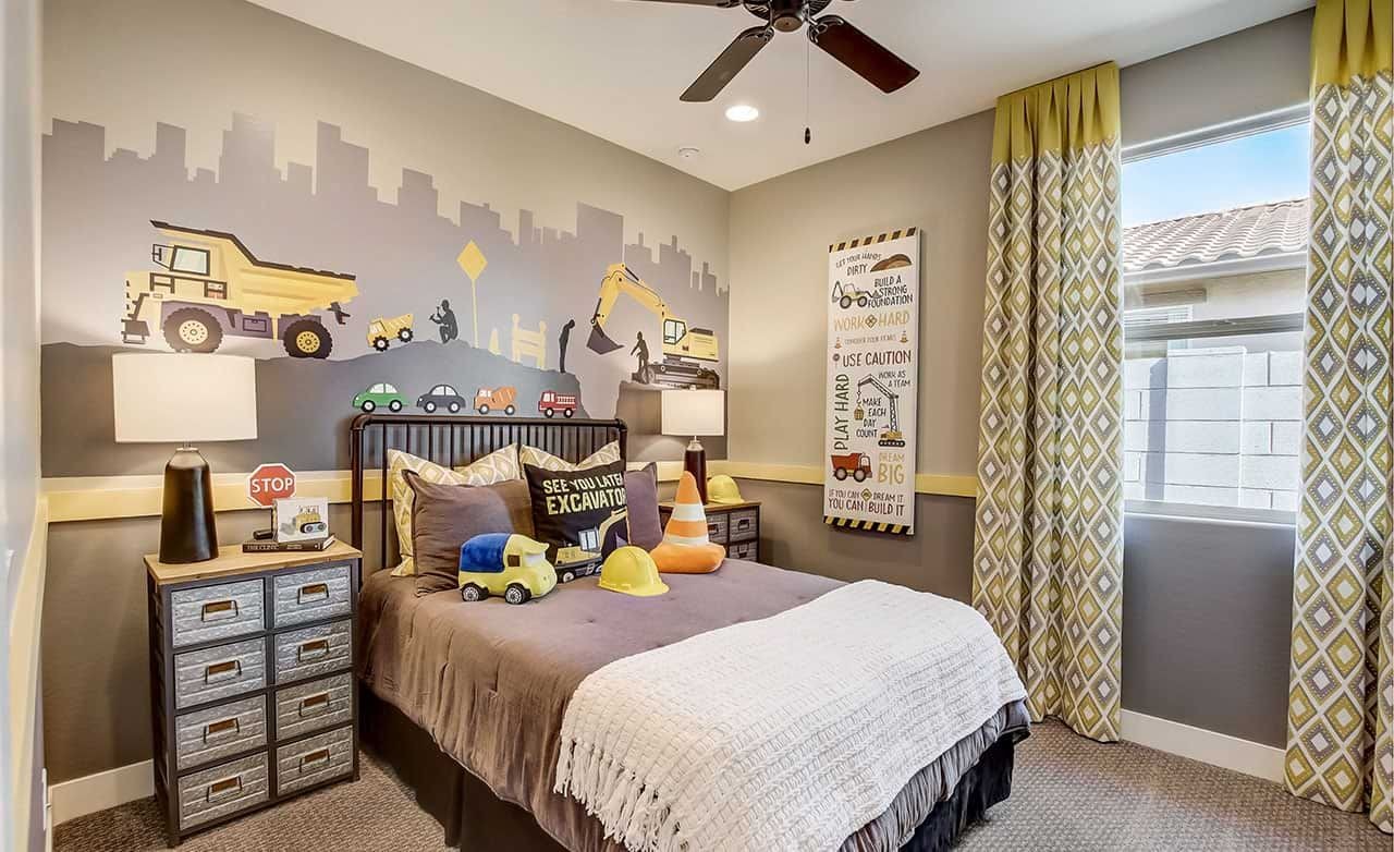 Child's room with construction-themed mural, stylish furnishings, and large window at Castillo at Anderson Parc.