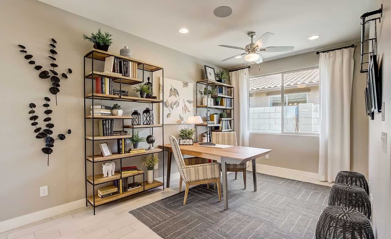 Modern home office with stylish shelving, decorative wall art, and large window in Anderson Parc community.