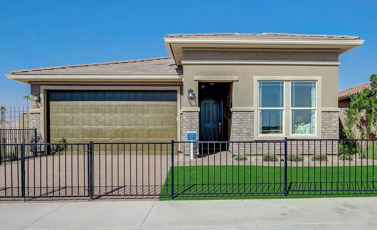Modern single-story home with brick accent facade, large garage, and manicured lawn in Anderson Parc community.