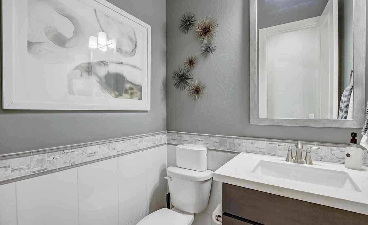 Modern bathroom with abstract art, elegant fixtures, and designer tiles in Mirada Crossing.