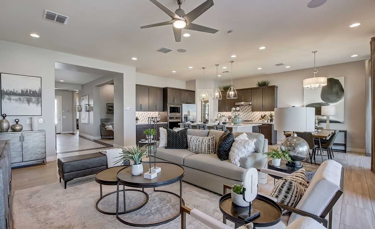 Luxury open-plan living space with modern kitchen, elegant lighting, and plush furnishings in Mirada Crossing.