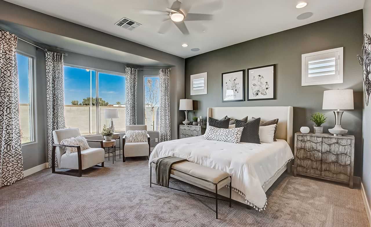 Luxurious bedroom featuring large windows, elegant decor, and premium furnishings in Mirada Crossing community.
