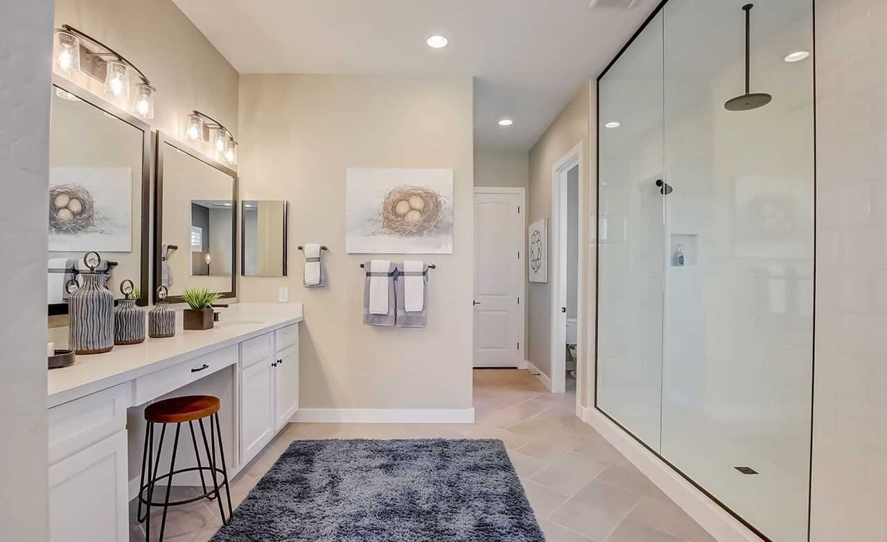 Luxurious Mirada Crossing bathroom features double vanity, glass shower, elegant lighting, modern decor, Arizona.