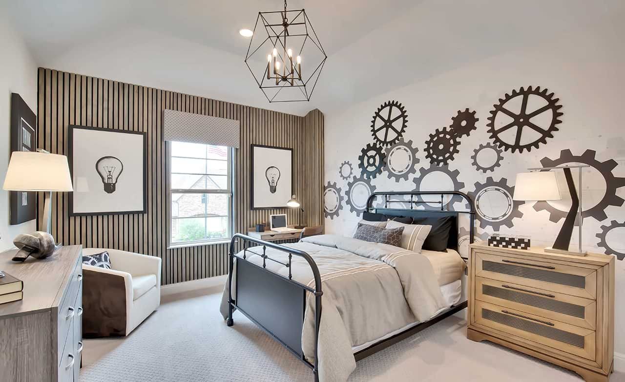 Modern bedroom with industrial decor, gear wall art, metal bed, wooden accent wall, Oaks at San Gabriel.