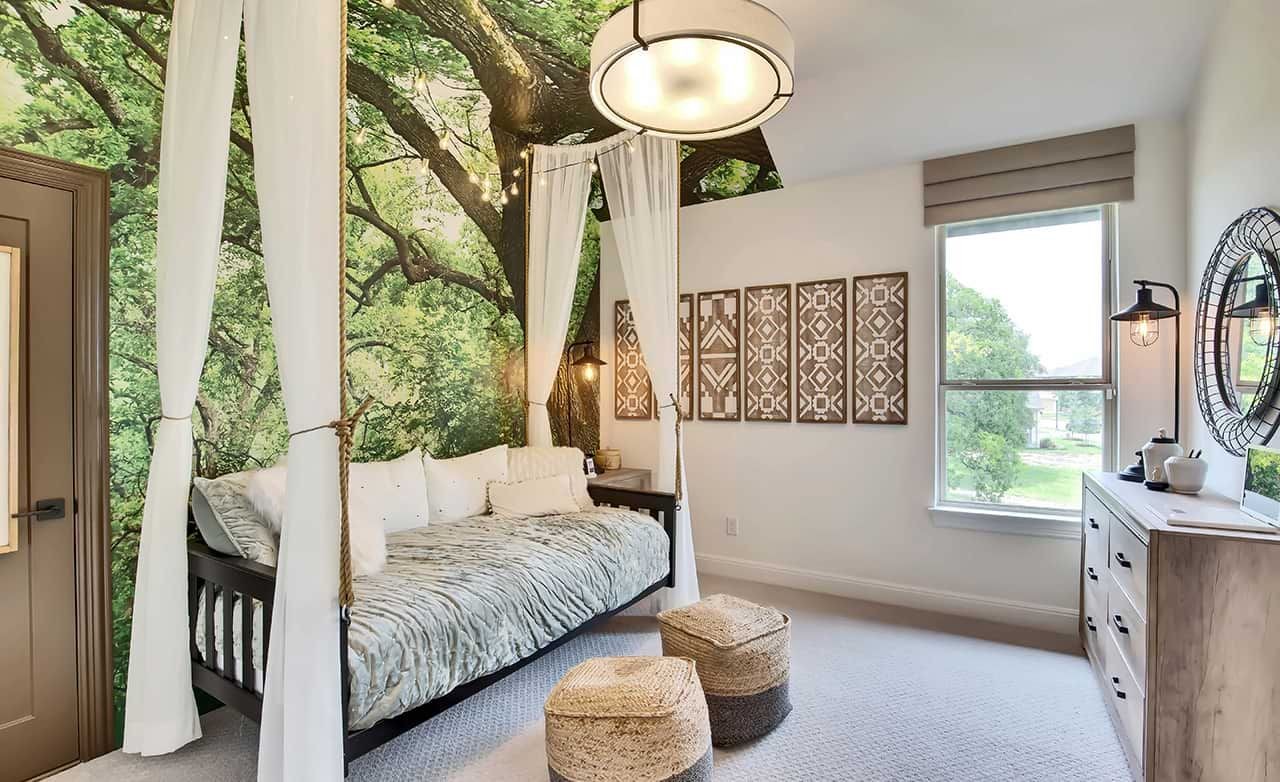 Bedroom with tree mural, modern lighting, elegant decor, window view. Oaks at San Gabriel community.