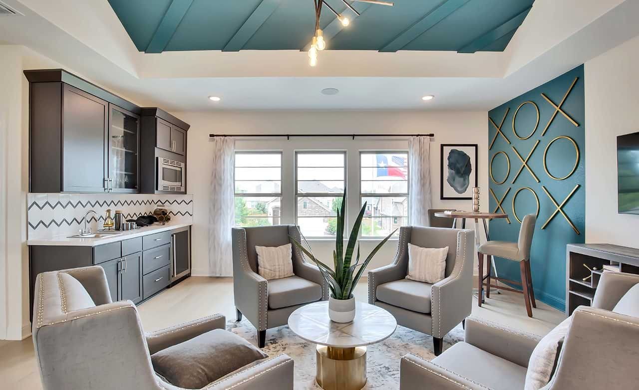Elegant living room with blue coffered ceiling, modern decor; Oaks at San Gabriel community, Texas.
