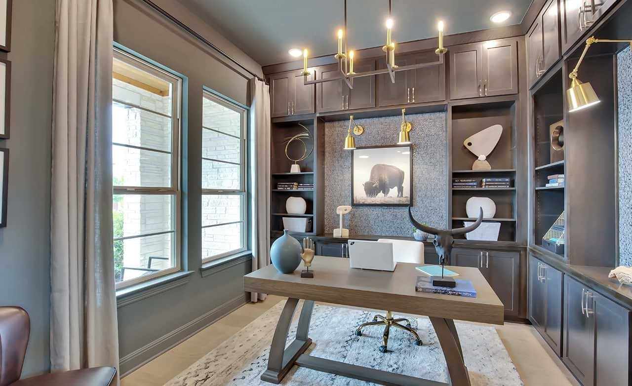 Luxurious home office with dark wood built-ins, modern chandelier, in Oaks at San Gabriel, Texas.