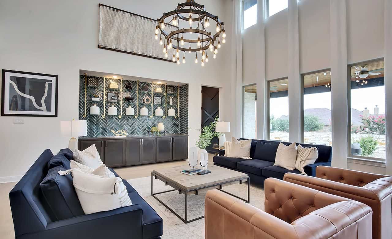 Elegant living room with high ceilings, chandelier, and modern decor at Oaks at San Gabriel, Georgetown, TX.