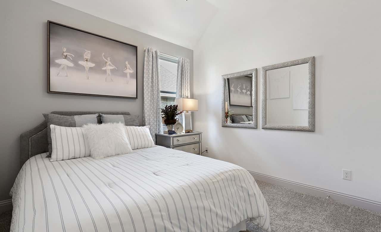 Elegant bedroom with gray walls, ballet art, plush bedding, large mirrors, and natural light at Thompson Farms.